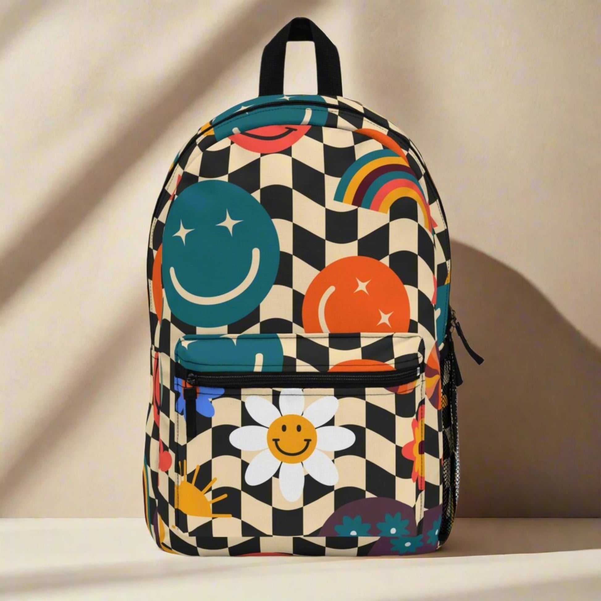 Image: Smiley Face Retro Checkerboard Backpack, with a black and tan checker pattern, and daisies, rainbows, suns and stars. The perfect vintage back to school bookbag for your hippie chick teen or tween, by jaecrece