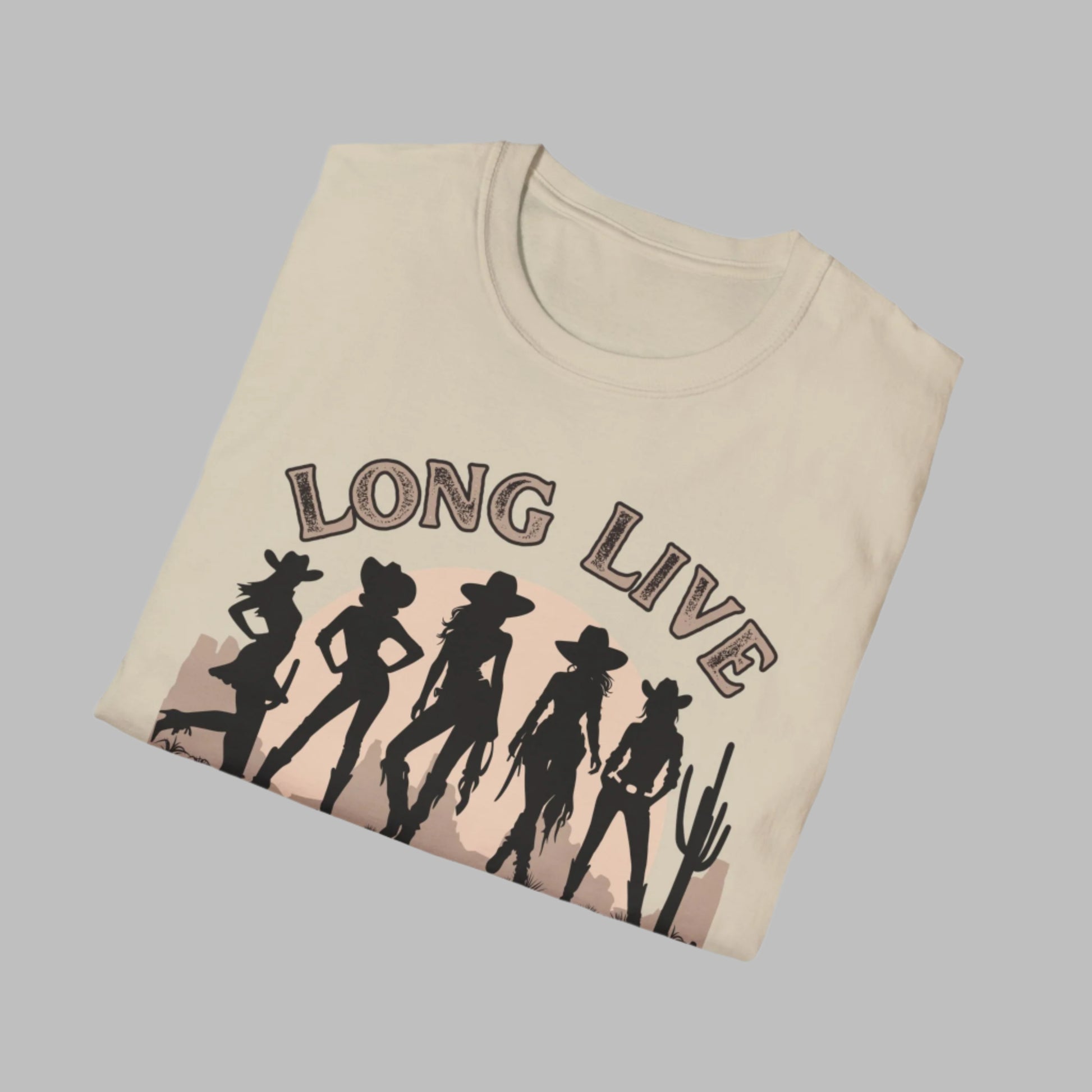 Image: A soft, oversized country tee with Long Live Cowgirls printed above five bold cowgirl figures, bringing vintage western style to life. The relaxed fit and earthy tones make it the perfect choice for music festivals, rodeos, and everyday country wear. Whether you are a true western spirit or just love rustic fashion, this shirt blends comfort and charm effortlessly, by jaecrece.