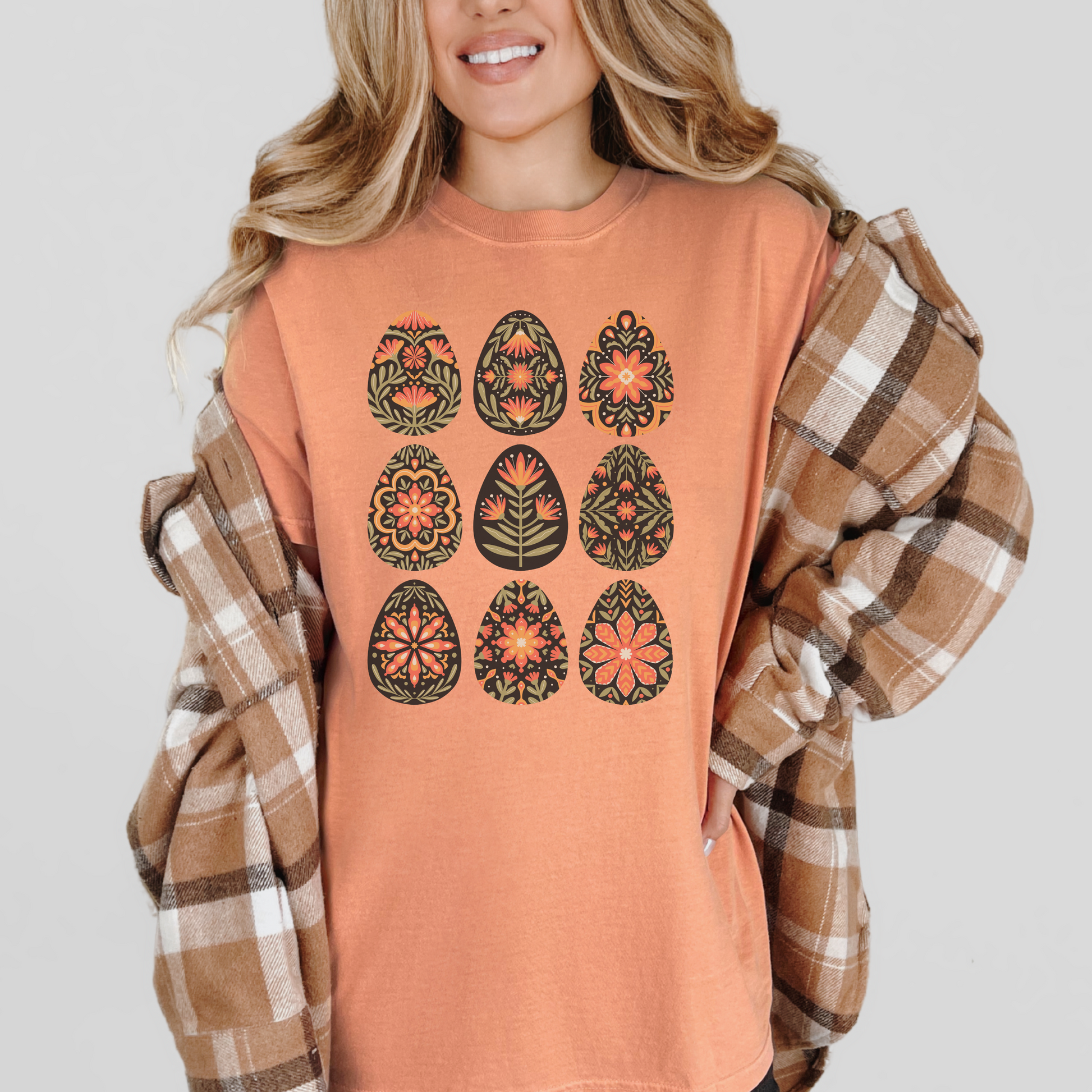 Image: This folk art Easter shirt features a vibrant floral and botanical Easter egg design with vintage Scandinavian influences. The intricate patterns reflect traditional Nordic craftsmanship, creating a timeless spring fashion statement. Perfect for casual outings or Easter festivities, this soft and stylish t-shirt brings together the beauty of cottagecore, boho aesthetics, and Swedish hygge in one charming piece, by jaecrece.