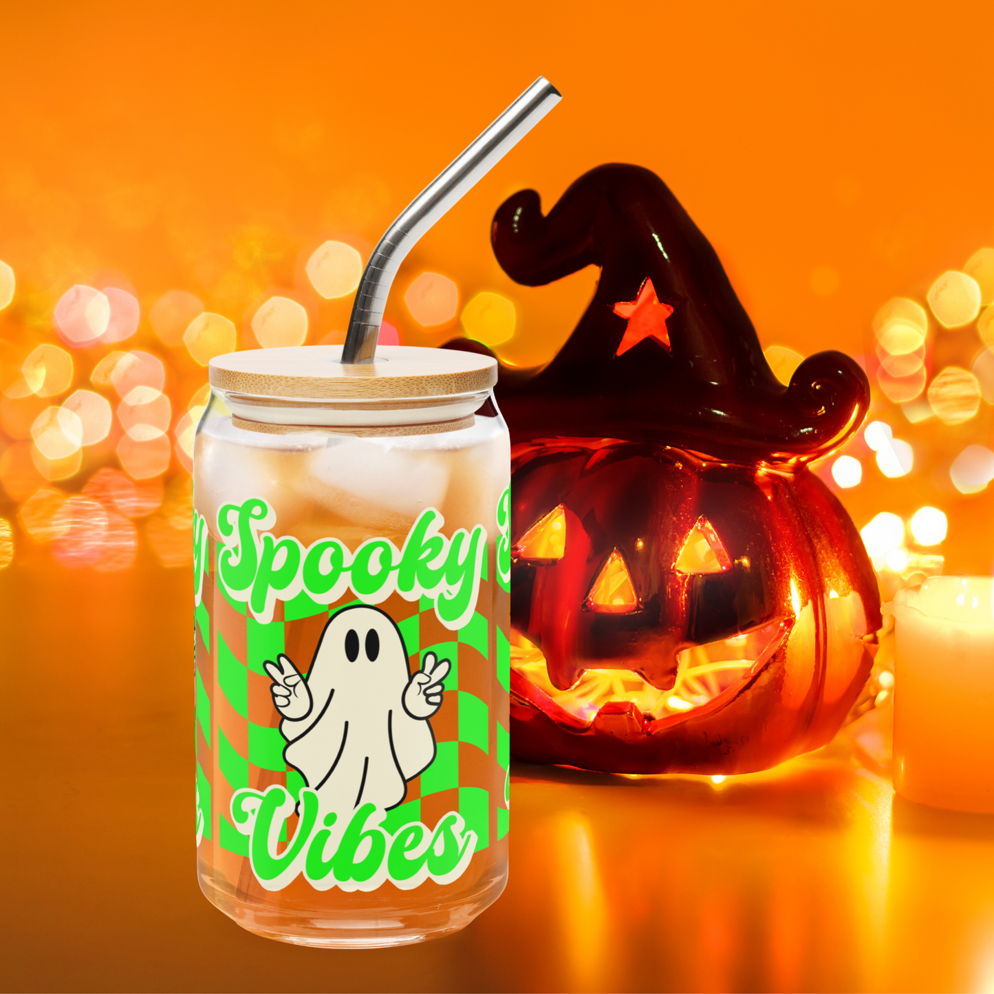 Set against a festive Halloween decor backdrop with pumpkins and candles, this 16 oz Spooky Vibes Sipper Glass is styled for gifting. Featuring a peace-sign ghost and neon green checkerboard pattern, it’s a charming reusable Halloween glass cup perfect for iced lattes or mocktails. Makes a spooky cute gift for teen girls, teachers, or party hosts who love fall drinkware and seasonal surprises.