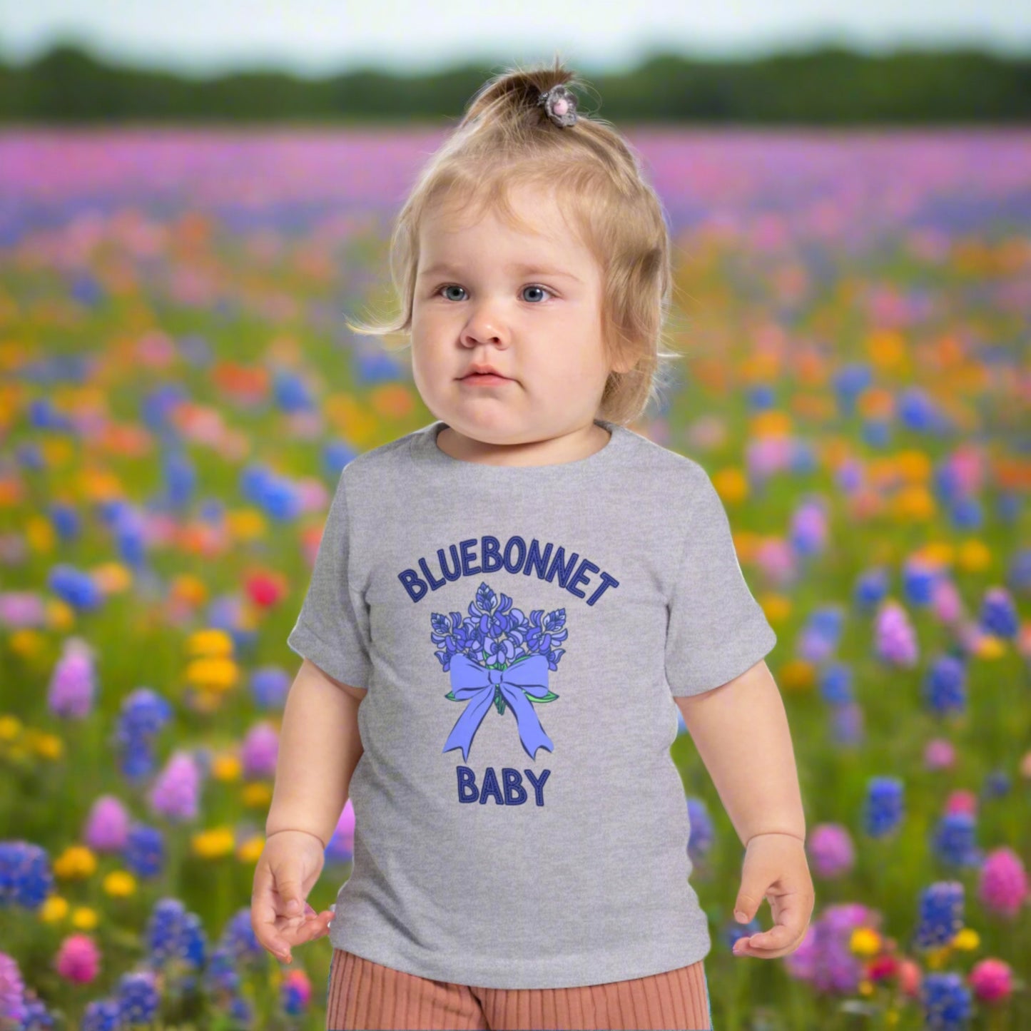 Image: A soft, breathable toddler t-shirt featuring a lovely bluebonnet print, celebrating the Texas state flower. Perfect for spring outings, this tee is ideal for bluebonnet field photos, playdates, or family picnics. A charming gift for baby showers or birthdays, it allows little Texans to embrace their roots. Its lightweight fabric ensures comfort while showcasing a nature-inspired design that makes any outfit extra special, by jaecrece.