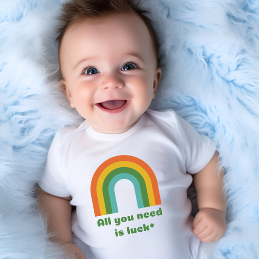 Image: St. Patricks Day Baby Bodysuit. This All You Need is Luck baby/ toddler onesie features a charming retro vintage design adorned with lucky shamrocks and rainbows. Matching adult and child tshirts and sweatshirts available, by jaecrece