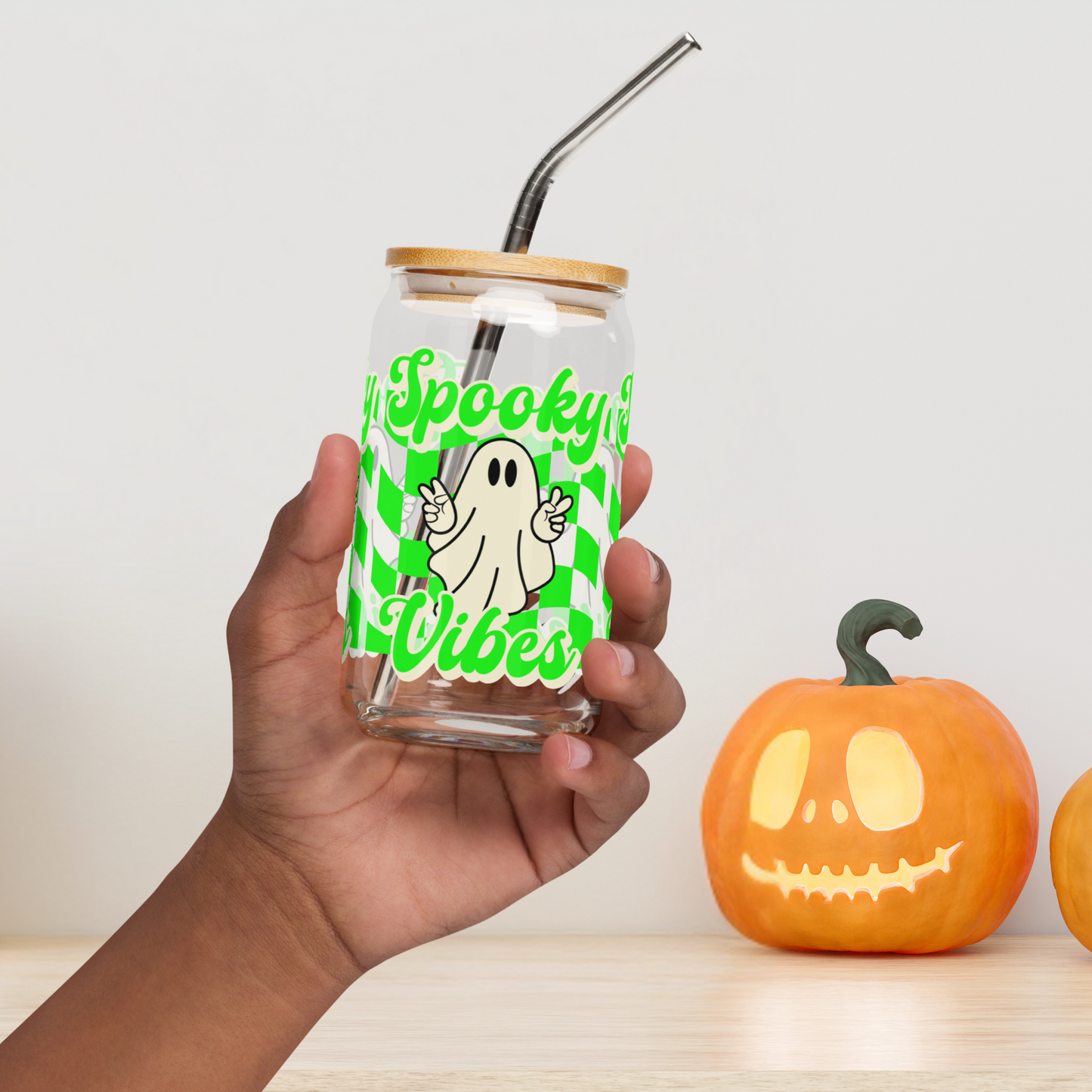 Detailed view of the “spooky vibes” text on this Halloween iced coffee cup. The stylized font complements the neon green checkerboard pattern and cheerful ghost, creating a fun and festive spooky tumbler. Ideal for Halloween drinkware collections, seasonal bar carts, or gifting to ghost lovers, party hosts, and iced coffee drinkers looking for fall-themed sipper glasses.