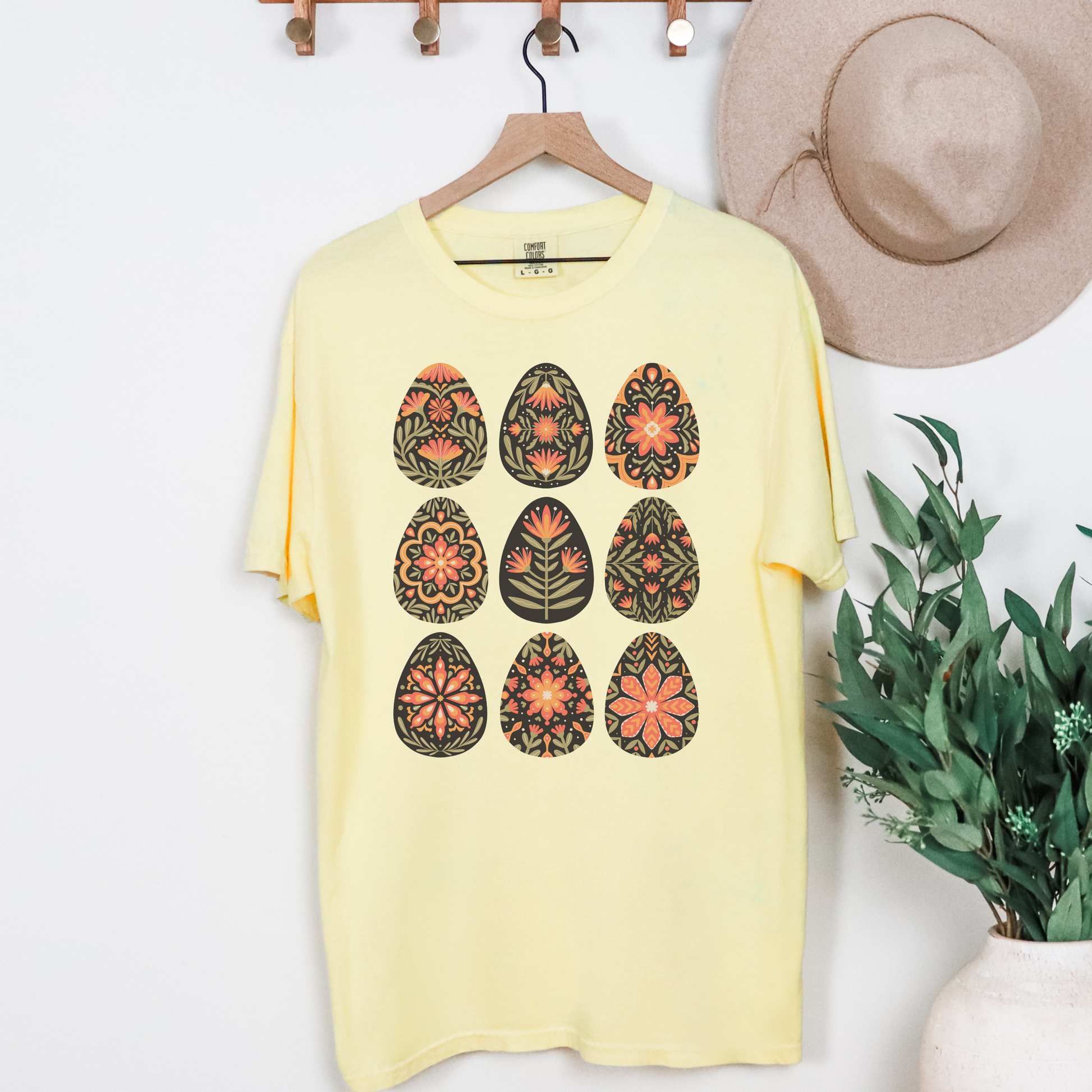 Image: This folk art Easter shirt features a vibrant floral and botanical Easter egg design with vintage Scandinavian influences. The intricate patterns reflect traditional Nordic craftsmanship, creating a timeless spring fashion statement. Perfect for casual outings or Easter festivities, this soft and stylish t-shirt brings together the beauty of cottagecore, boho aesthetics, and Swedish hygge in one charming piece, by jaecrece.
