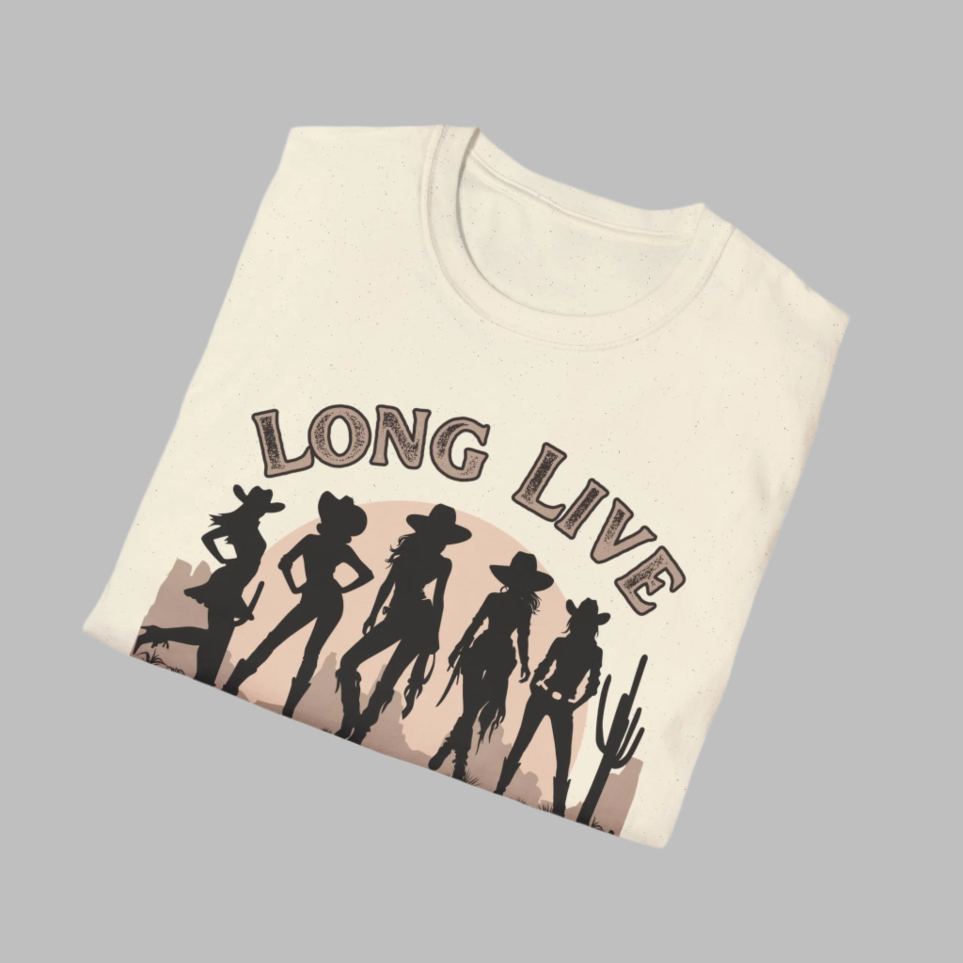 Image: A soft, oversized country tee with Long Live Cowgirls printed above five bold cowgirl figures, bringing vintage western style to life. The relaxed fit and earthy tones make it the perfect choice for music festivals, rodeos, and everyday country wear. Whether you are a true western spirit or just love rustic fashion, this shirt blends comfort and charm effortlessly, by jaecrece.