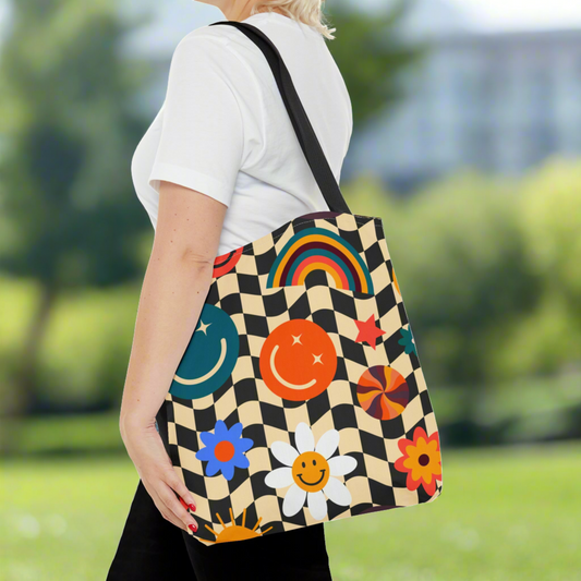 Smiley Face Checkerboard Canvas Tote Bag. This cute reusable carryall is eco friendly, and features a black and khaki checkerboard background, with smiley face, rainbow and daisy graphics. by jaecrece.com