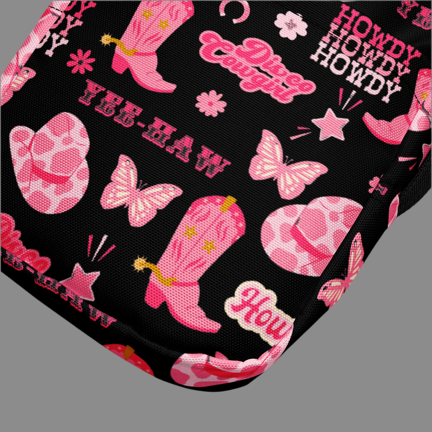 Image: Disco Cowgirl Canvas Crossbody Bag. This small black sling bag features a western glam hot pink pattern of cowgirl boots, cowgirl hats, butterflies and horseshoes. The pattern reads Disco Cowgirl, Yee-Haw and Howdy. The perfect mini backpack for bachelorette parties, gifts for teens or tweens, or trips to the state fair, by jaecrece