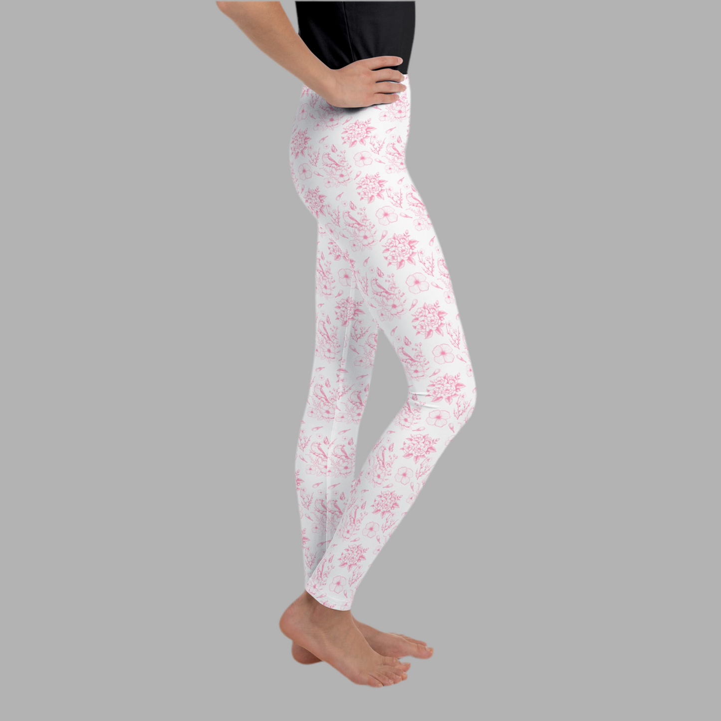 Image: Girls pink toile leggings in youth sizes 8 to 20, designed with a romantic floral pattern that captures classic elegance. These comfy, stretch leggings are ideal for tweens who love soft colors and vintage vibes. Whether worn to school, layered under dresses, or styled for spring photos, this toile print adds timeless charm to any outfit. Part of a matching family look collection, by jaecrece.