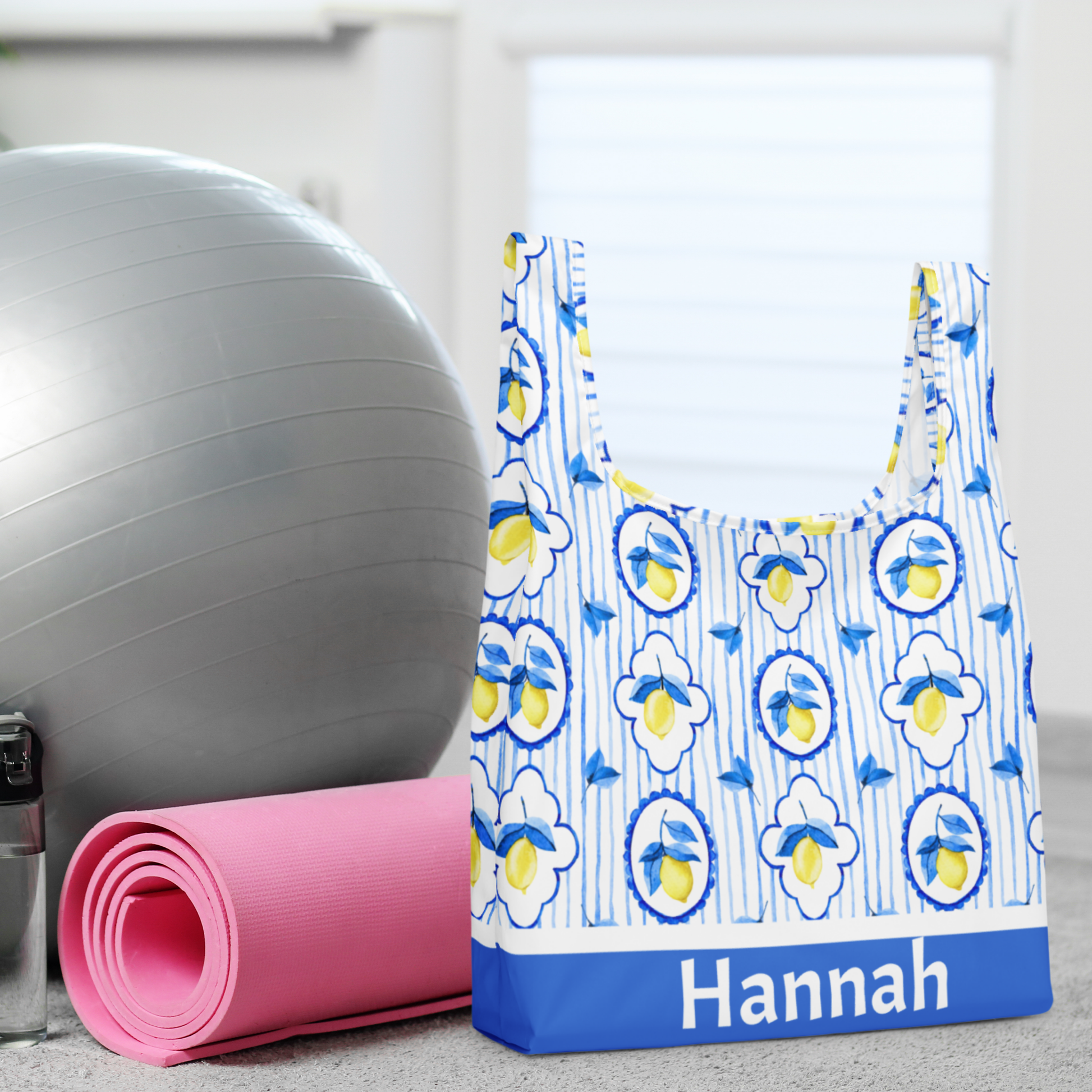 Chic Amalfi Coast inspired tote bag featuring bright lemons and blue Italian tile, ideal for summer vacations, market trips, or everyday errands. Made from eco friendly polyester, this lightweight yet durable reusable bag measures 15.5" × 25.3" and folds up neatly with an elastic band for compact storage. Perfect as a Mother’s Day gift, teacher appreciation bag, or stylish grocery tote with Italian summer flair.