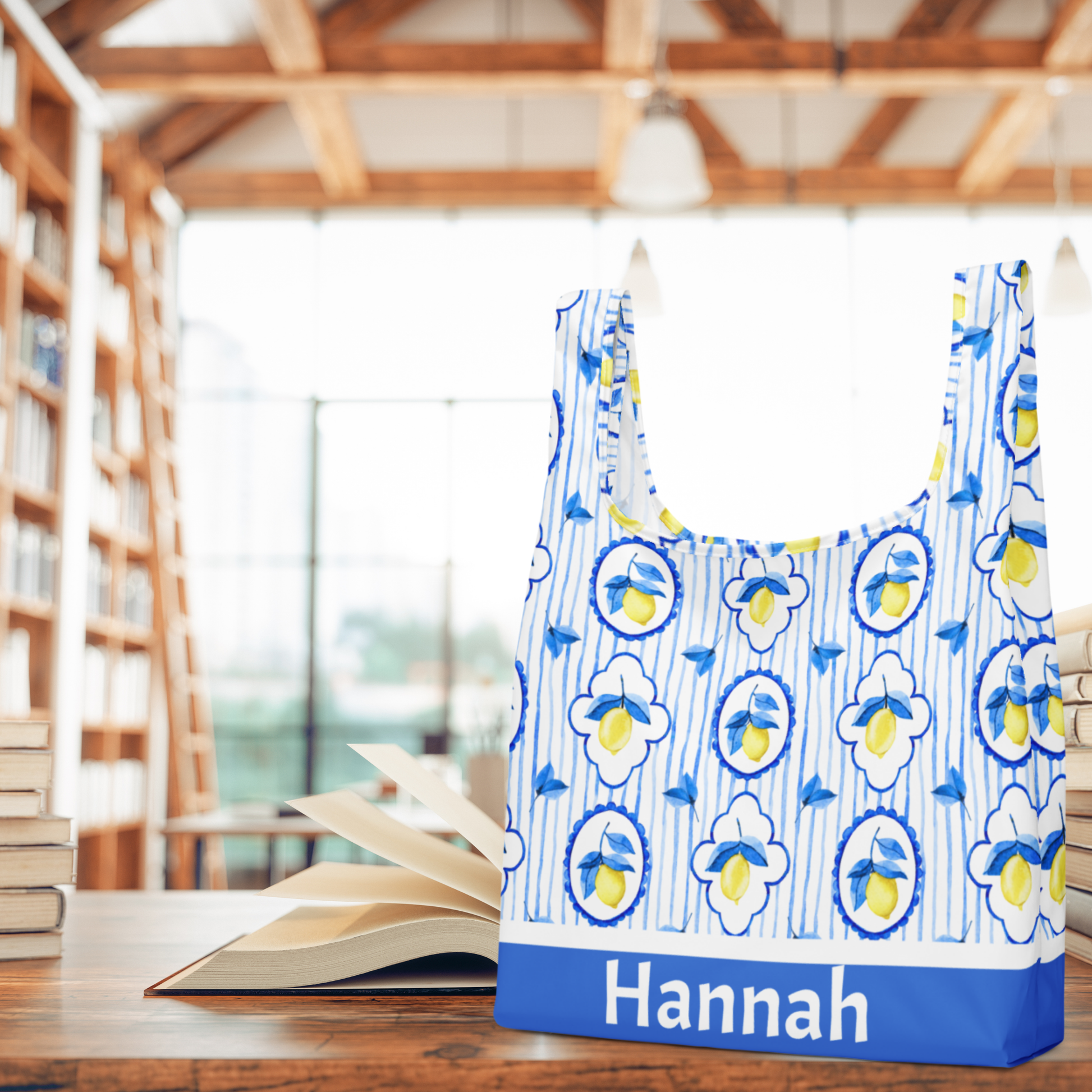 Reusable Amalfi Lemon Tote Bag designed with straps seamlessly built into the body of the bag, making it stronger than traditional totes. Featuring a bright lemon print inspired by the Amalfi Coast, this eco friendly market bag is washable, foldable, and lightweight. Dimensions are 15.5" × 25.3", making it roomy for groceries, beach towels, or travel essentials. A thoughtful Italian inspired gift for her, teachers, or moms.