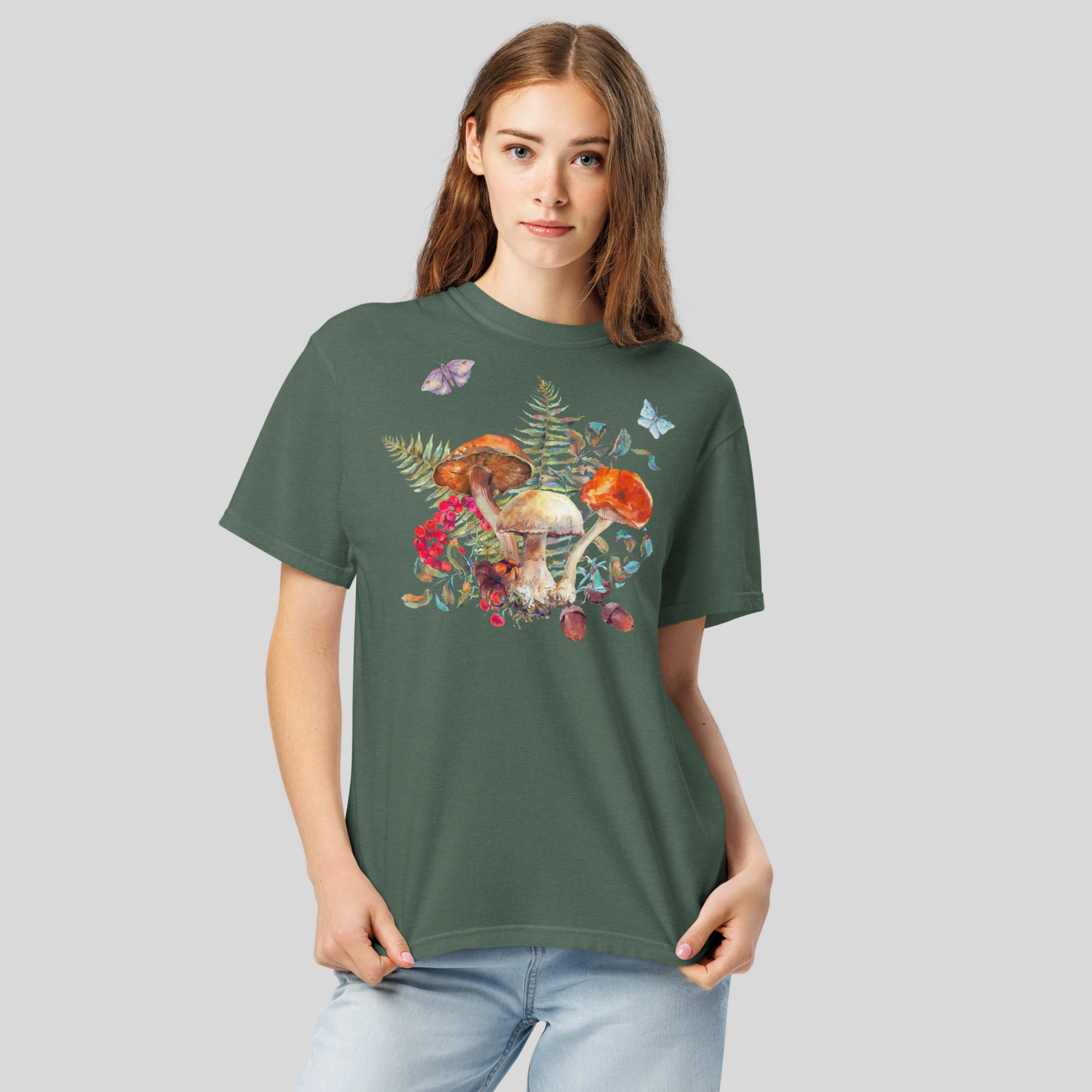 Whimsical Boho Botanical Mushroom Shirt printed on a Comfort Colors 1717 t shirt, featuring forest-inspired mushrooms, ferns, butterflies, and moths. Available in earthy tones Ivory, Blue Spruce, Butter, Granite, and Pepper, this unisex woodland shirt is perfect for goblincore, fairyboho, cottagecore, and boho mystic aesthetics. Soft and relaxed, ideal for layering, fall wardrobe styling, or casual outdoor wear. Made-to-order and eco-conscious, this botanical graphic tee is a great gift for mushroom lovers,