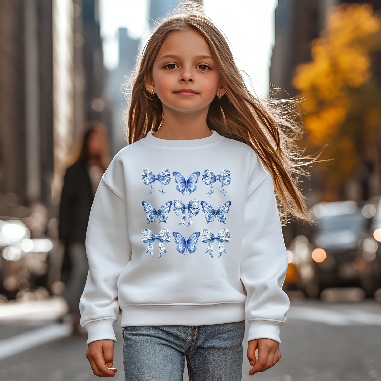Girls Blue Toile Sweatshirt in Navy and White with whimsical butterfly and bow details in a timeless toile print. Designed for girls and tweens XS–XL, this soft and cozy pullover fits the soft girl aesthetic, coquette style, and coastal cowgirl trends. Perfect for spring and fall layering, casual playdates, or school outfits. Part of a matching family collection, coordinate with siblings or mom for photos. Makes a thoughtful birthday gift or wardrobe staple blending vintage charm and modern girls fashion.