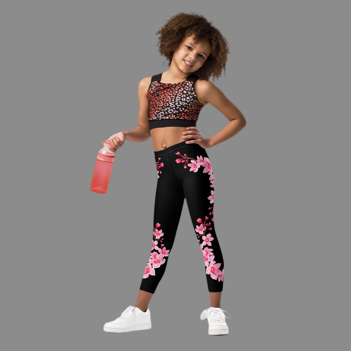 Image: Japanese Cherry Blossom Girls and Toddler Leggings, in sizes 2T, 3t, 4T, 5T, 6, 6X and 7. Black leggings with a swirl of Japanese cherry blossoms going down the outside of each leg. Elastic, soft, and durable with vibrant colors. Part of a matching collection for younger children and women, each pair is precision-cut and hand-sewn for a perfect fit.