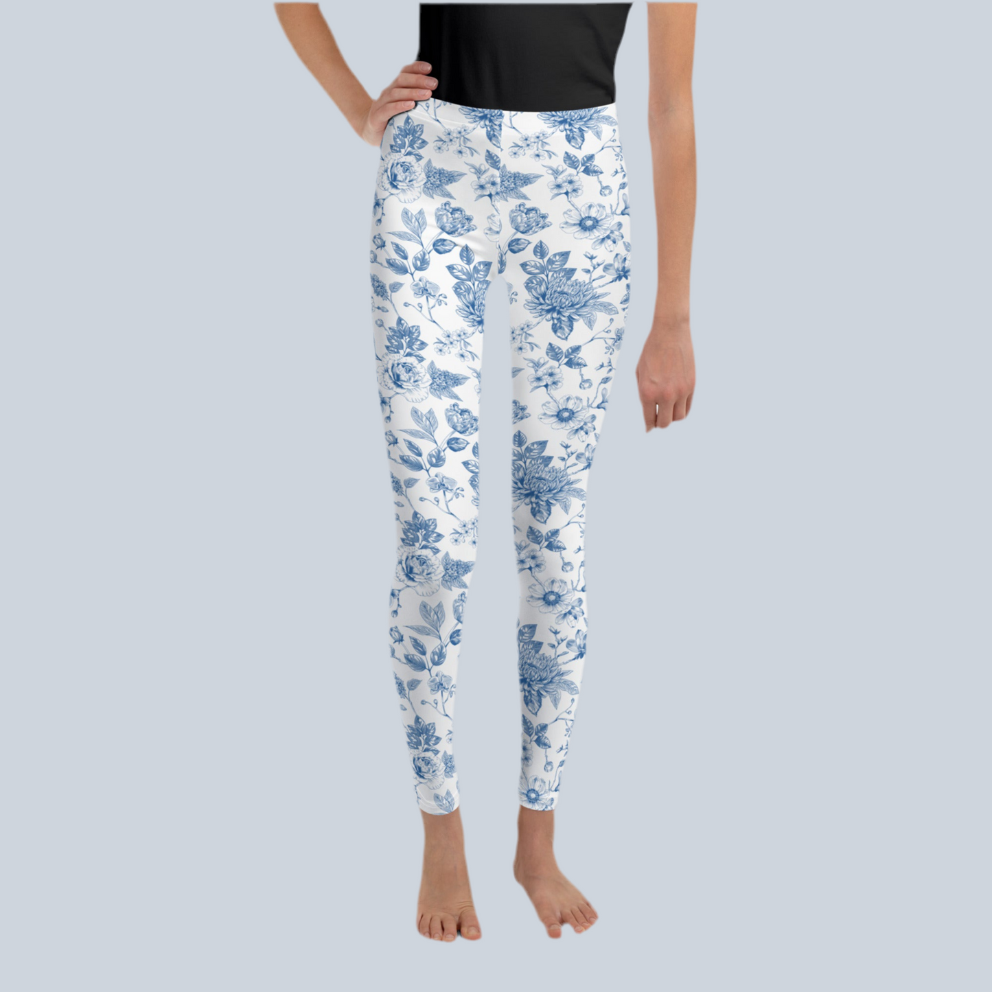 Image: Stylish youth leggings for girls in a blue toile pattern, available in tween and teen sizes 8 to 20. Designed for comfort and movement, these leggings are ideal for active kids who love fashion and floral vintage prints. Great for family vacations, weekend wear, or spring and fall photoshoots. Pair them with a white tee or soft pastel top for an adorable seasonal outfit, by jaecrece.