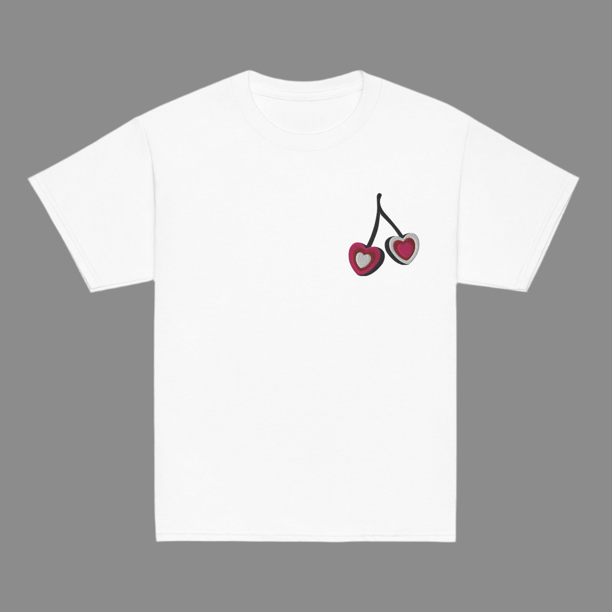 Image: Cherry Embroidery Shirt for Girls. This Valentines Day crewneck tee features two embroidered cherries on the left chest in red, pink and white with black stems. Great gift for tweens and toddlers who love the cherrycore aesthetic, by jaecrece