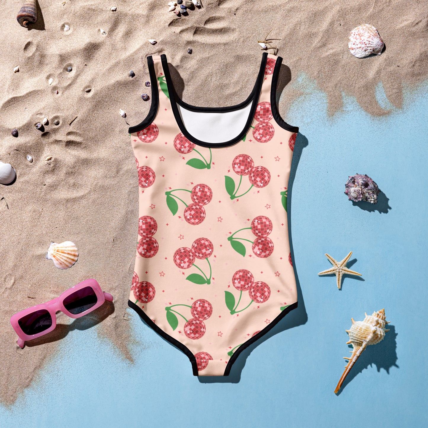 Trendy toddler girl swimsuit in sizes 2T–7 with pink background and red disco cherries, part of a matching family swimwear set. Features UPF 38–40, double-layered front, and four-way stretch material that keeps little ones comfy and stylish. This fun one-piece is perfect for family pool days, beach trips, and stylish summer adventures with mom in her matching adult version.