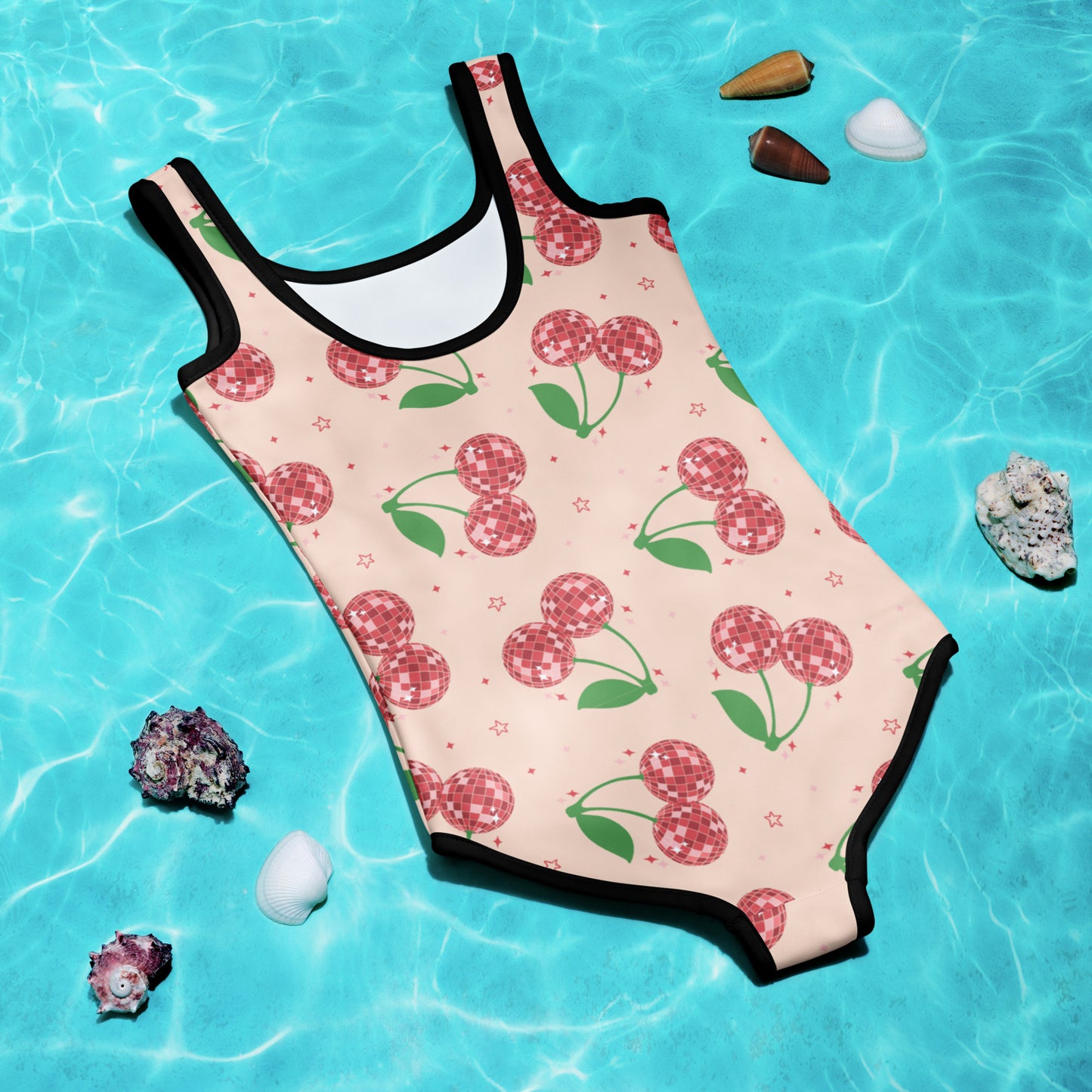 Playful and bright kids swimsuit featuring red disco cherries on a bubblegum pink background, made for beach vacations and summer trips. Available in toddler sizes 2T–7 and designed with a double-layered front and UPF 38–40 fabric for sun-safe fun. This swimwear is part of a family matching set, perfect for vacation photos, poolside lounging, and summer adventures with the whole crew.