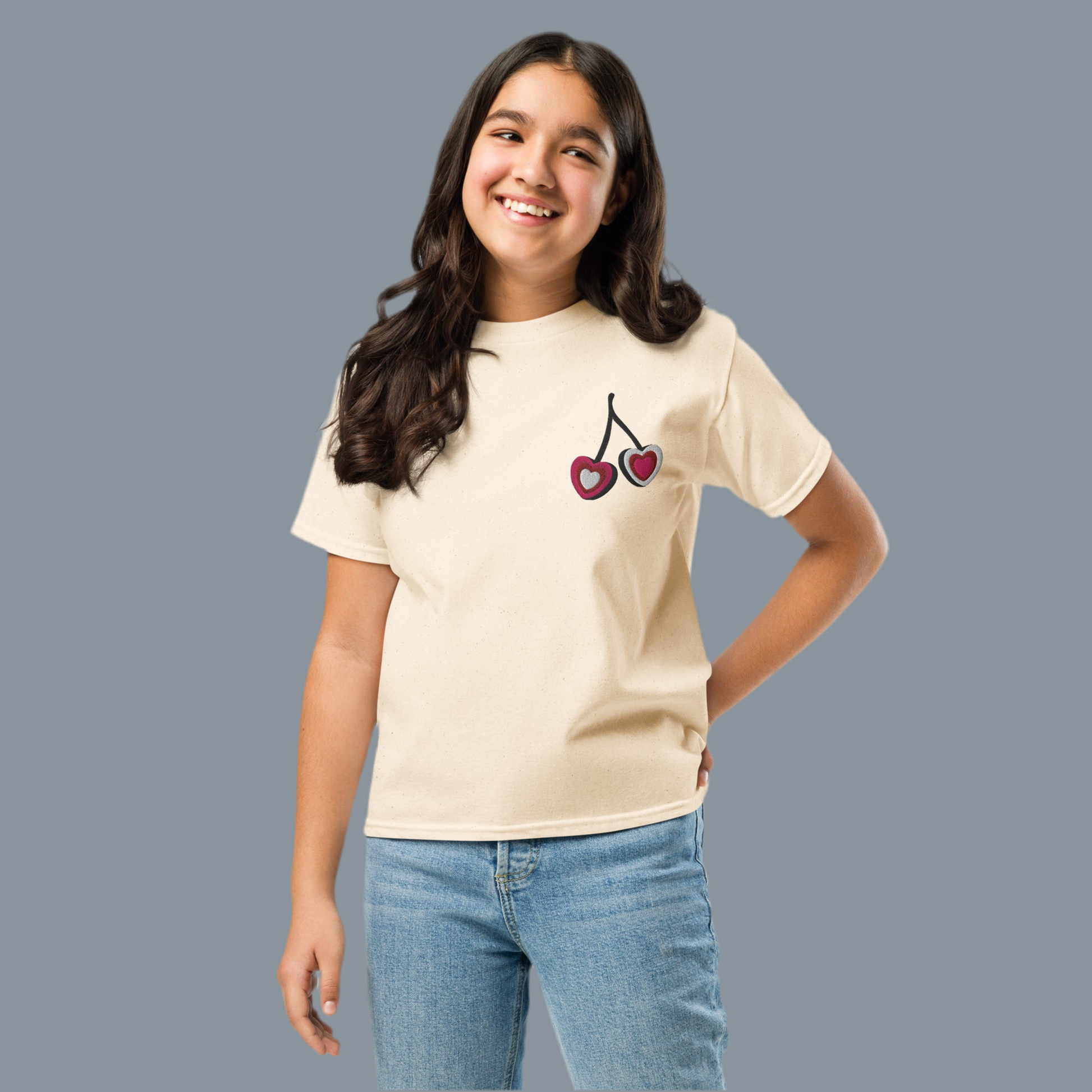 Image: Cherry Embroidery Shirt for Girls. This Valentines Day crewneck tee features two embroidered cherries on the left chest in red, pink and white with black stems. Great gift for tweens and toddlers who love the cherrycore aesthetic, by jaecrece