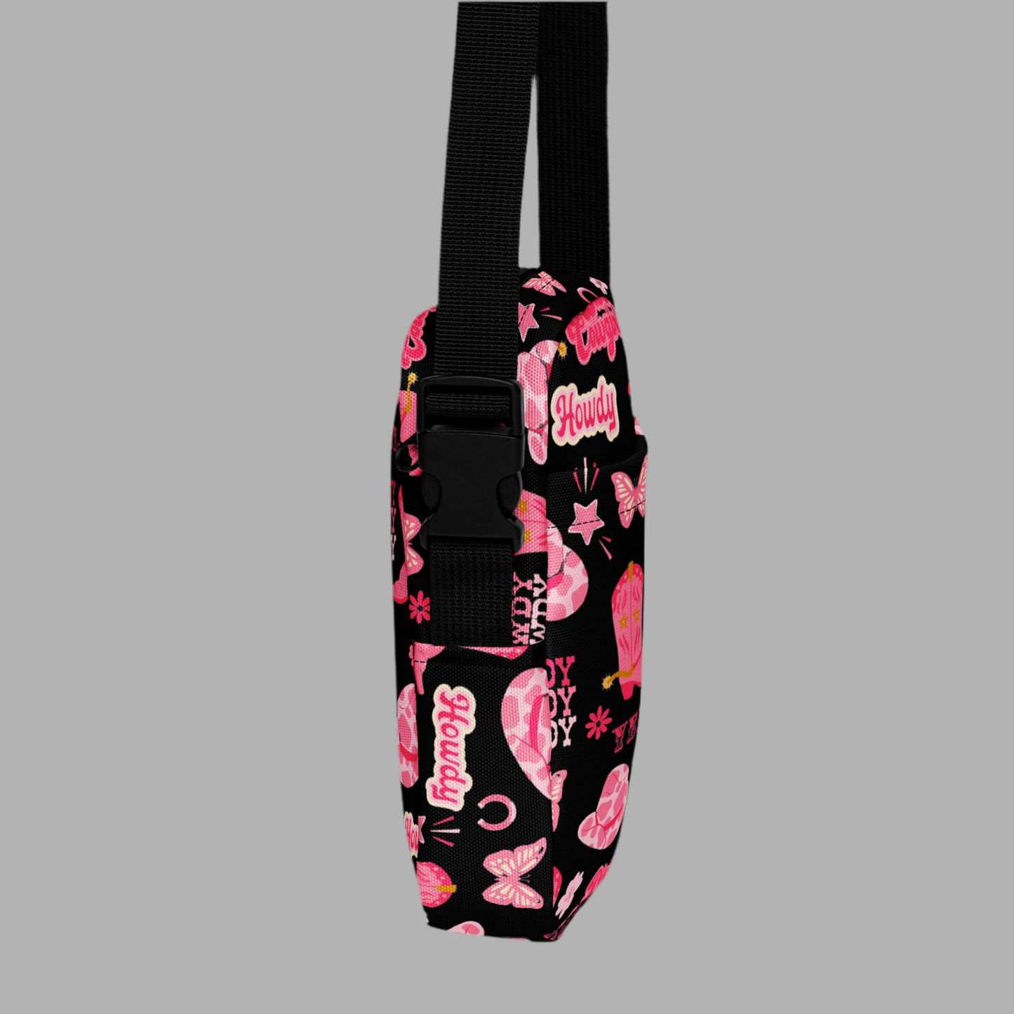 Image: Disco Cowgirl Canvas Crossbody Bag. This small black sling bag features a western glam hot pink pattern of cowgirl boots, cowgirl hats, butterflies and horseshoes. The pattern reads Disco Cowgirl, Yee-Haw and Howdy. The perfect mini backpack for bachelorette parties, gifts for teens or tweens, or trips to the state fair, by jaecrece
