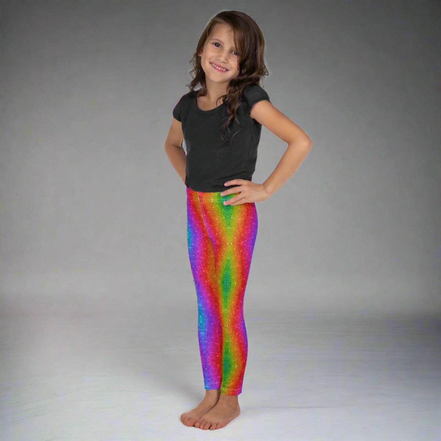 Toddler and girls’ faux glitter leggings with a holographic swirl print in rainbow colors, available in sizes 2T to 7. Perfect for toddlers and little girls at Pride, Mardi Gras, festivals, or dance class. These stretchy, comfortable leggings are part of a family matching collection that celebrates color, fun, and movement. A perfect mix of style and comfort.