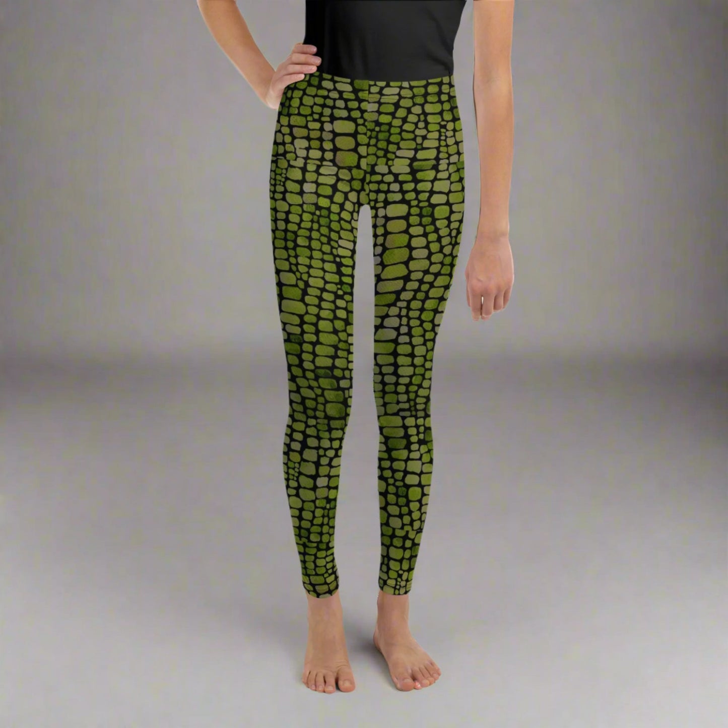 Reptile print youth girls leggings, size 8-20. These green yoga pants have a black reptile print pattern. These tights are available in plus/ extended sizes, and are perfect for casual wear, cosplay, Halloween Trick or treating or yoga class. Similar to a snake, lizard or dinosaur print, by jaecrece