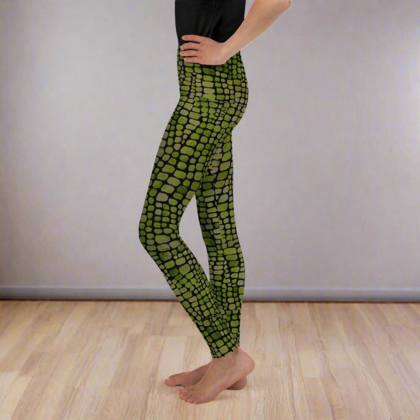 Reptile print youth girls leggings, size 8-20. These green yoga pants have a black reptile print pattern. These tights are available in plus/ extended sizes, and are perfect for casual wear, cosplay, Halloween Trick or treating or yoga class. Similar to a snake, lizard or dinosaur print, by jaecrece