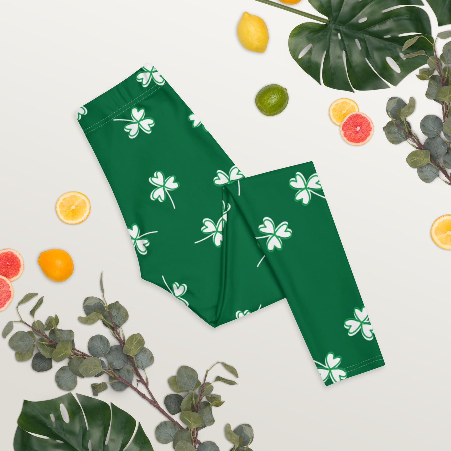 Green shamrock yoga pants with a mid rise waistband and ankle length design, perfect for St. Patrick's Day celebrations, themed outfits, and lucky holiday gifts