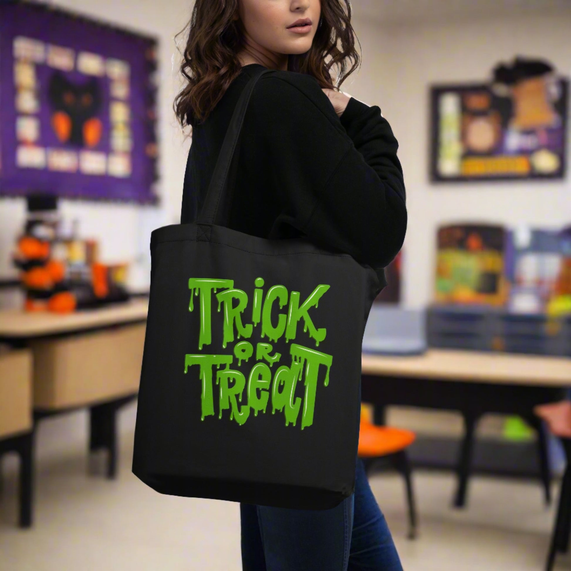 Organic Cotton Trick or Treat Tote Bag featuring bold green ooze text on black fabric, a sustainable and stylish Halloween accessory. This reusable trick-or-treat bag is durable enough for big candy hauls, lightweight for kids, and strong enough for everyday use. With roomy dimensions and sturdy straps, it doubles as a Halloween gift bag, eco-friendly grocery tote, or spooky season carryall for parties and fall outings.