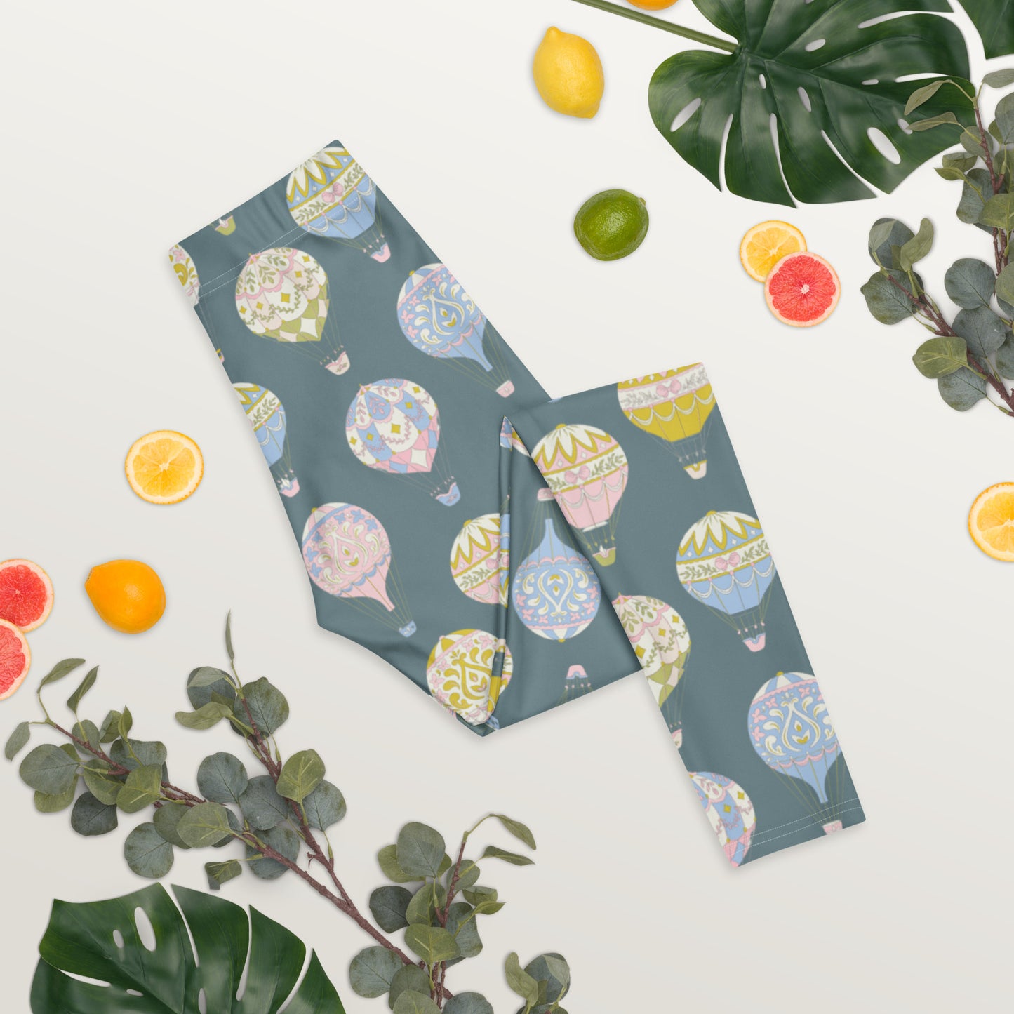 Whimsical Hot Air Balloon Print Women’s Leggings with soft pastel designs on a blue-gray base. Crafted with premium microfiber yarn and four-way stretch fabric for comfort and durability. Mid-rise waist and ankle-length fit make these leggings perfect for yoga, errands, or travel. Pairs beautifully with matching girls’ leggings for adorable mommy and me sets.