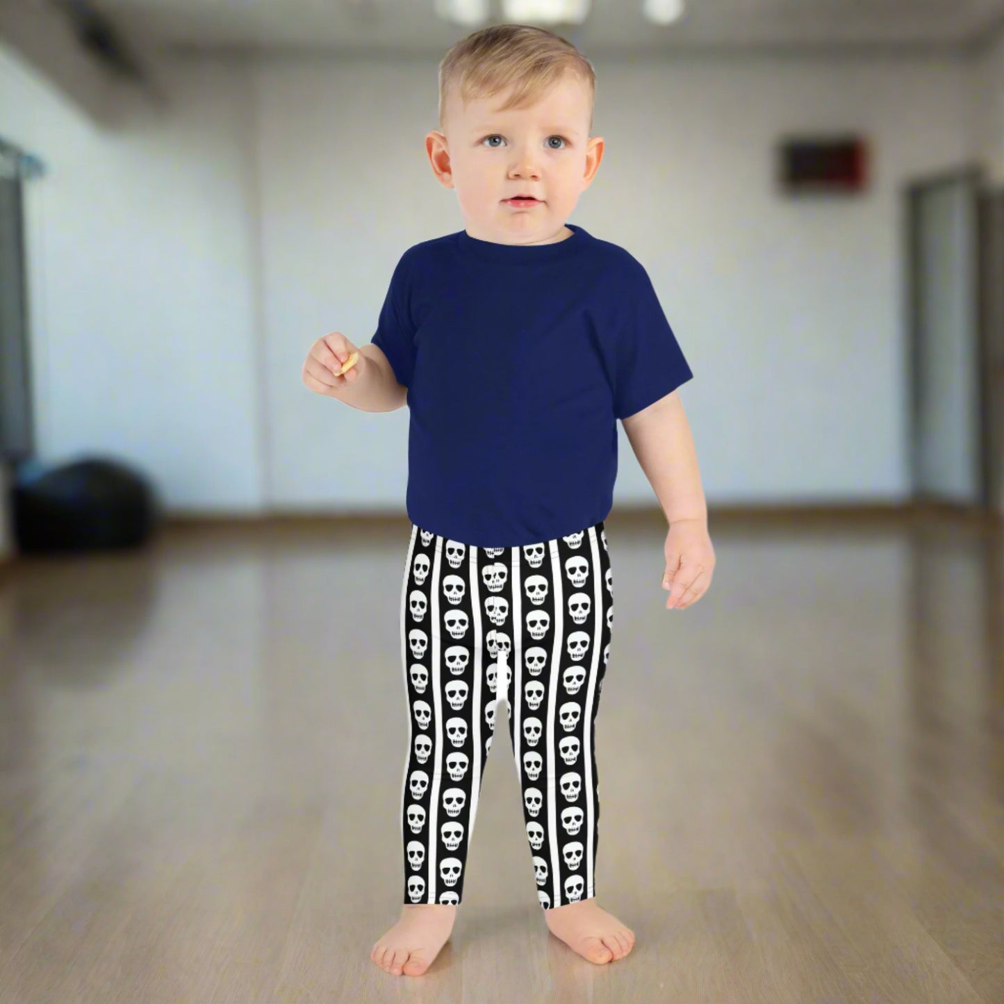 Image: These striped skull leggings for toddlers and kids offer spooky style in a comfy package. The bold black and white stripes give circus vibes while skull details add a fun Halloween touch. Whether paired with a tee or layered under a costume, they’re perfect for themed playdates or festive family photos. Available in multiple child and toddler sizes, by jaecrece.