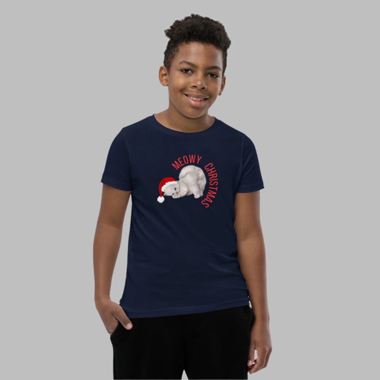 Meowy Christmas youth tee with an adorable gray kitten wearing a Santa hat, perfect for boys and girls who love cats and holiday fun. Available in youth sizes S–XL, this unisex Christmas shirt is ideal for festive events, family photos, and cozy winter days. A playful and funny holiday gift for cat lovers and kids. Pairs well with matching family shirts and Christmas pajama themes for sibling sets.