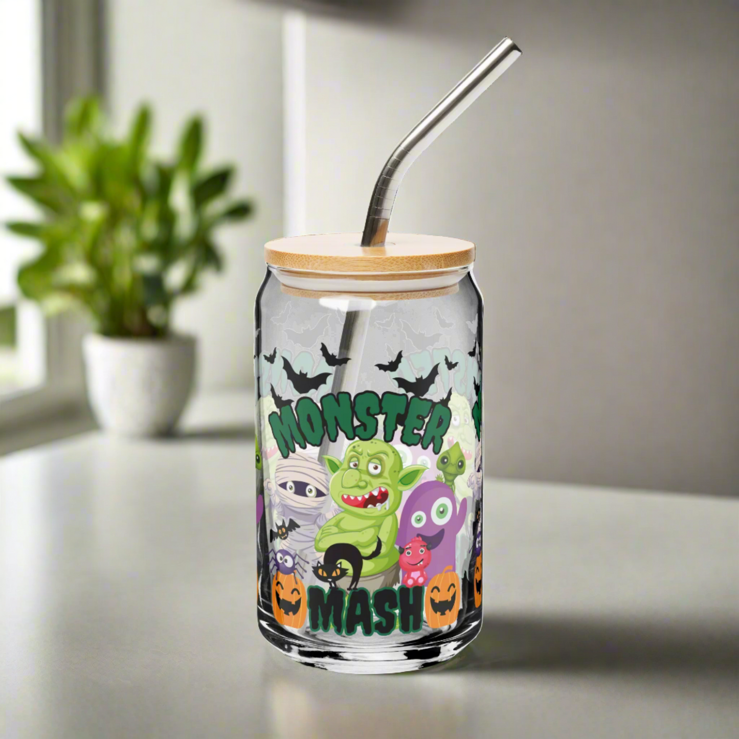 Spooky and fun Monster Mash 16 oz glass can with bamboo lid and reusable straw, decorated with colorful monsters, jack o’ lanterns, and bats. Great Halloween iced coffee cup, soda glass, or cocktail tumbler for seasonal gatherings, parties, or cozy nights at home. Makes a unique eco-friendly fall gift for friends, teachers, or loved ones. Festive Halloween drinkware and trendy reusable sipper glass for spooky season.
