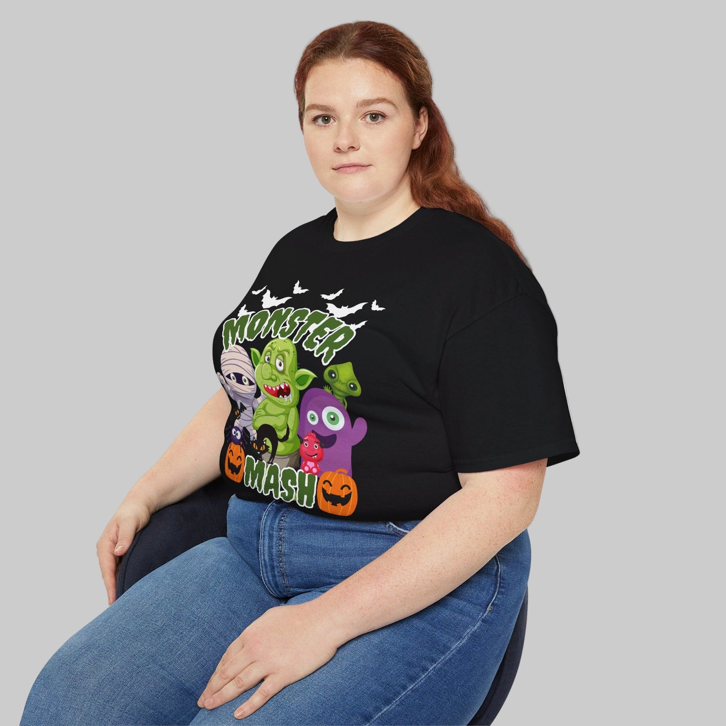 Unisex Halloween tee with cartoon monster mash design, showing friendly spooky characters including a mummy, pumpkins, bats, a troll, and spider. Printed on the high-quality Gildan 2000 shirt in soft cotton, available in adult sizes S–5XL and classic colors black or charcoal. This festive t-shirt is perfect for trick-or-treating, fall festivals, haunted houses, or Halloween parties, and makes a great Halloween gift or seasonal wardrobe staple.
