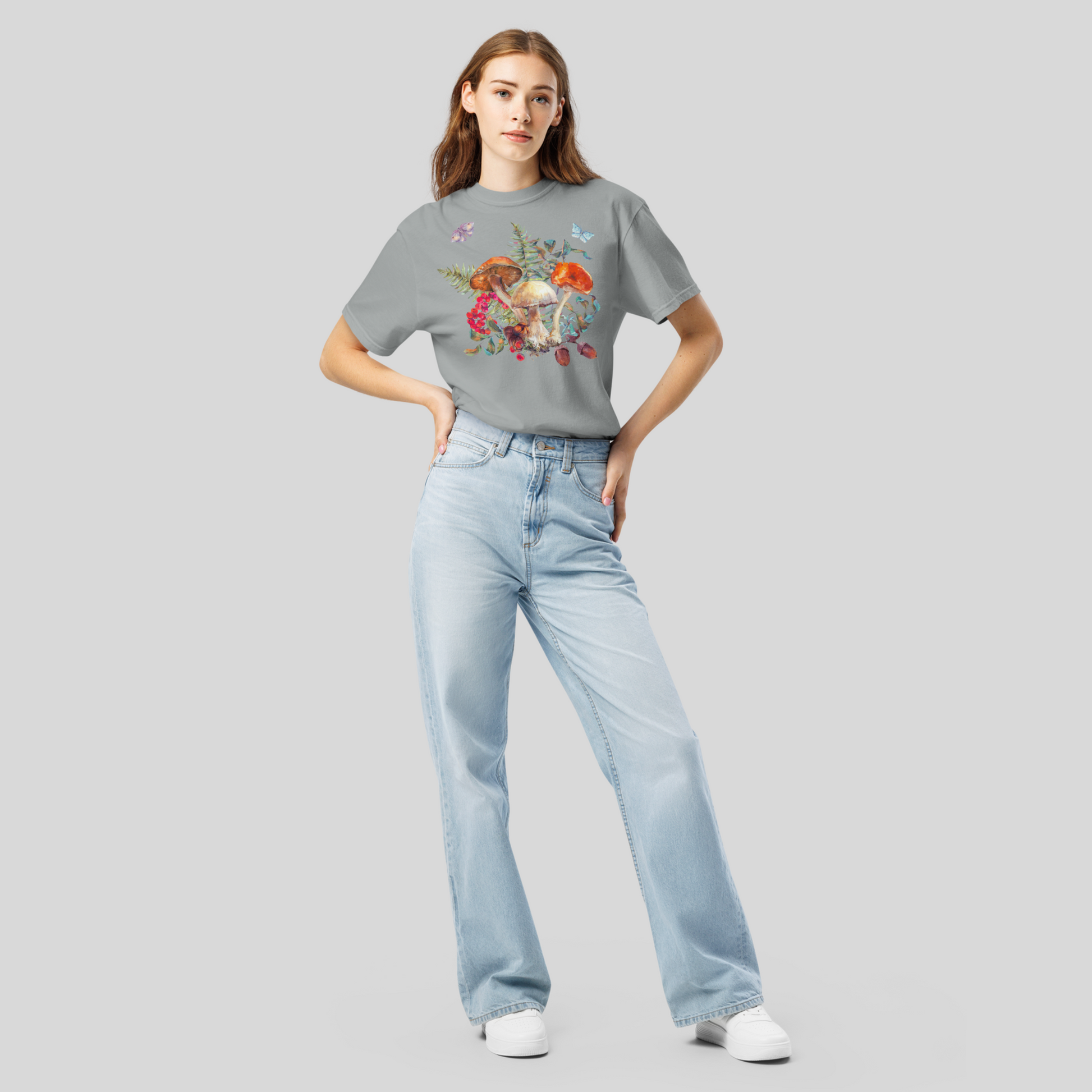 Comfort Colors 1717 Boho Botanical Mushroom Shirt with whimsical woodland mushrooms, ferns, butterflies, and moths printed in earthy tones Ivory, Blue Spruce, Butter, Granite, and Pepper. Perfect for goblincore, fairyboho, cottagecore, and boho mystic aesthetics, this soft and relaxed unisex shirt works well for fall and autumn layering, casual outfits, or cozy everyday wear.