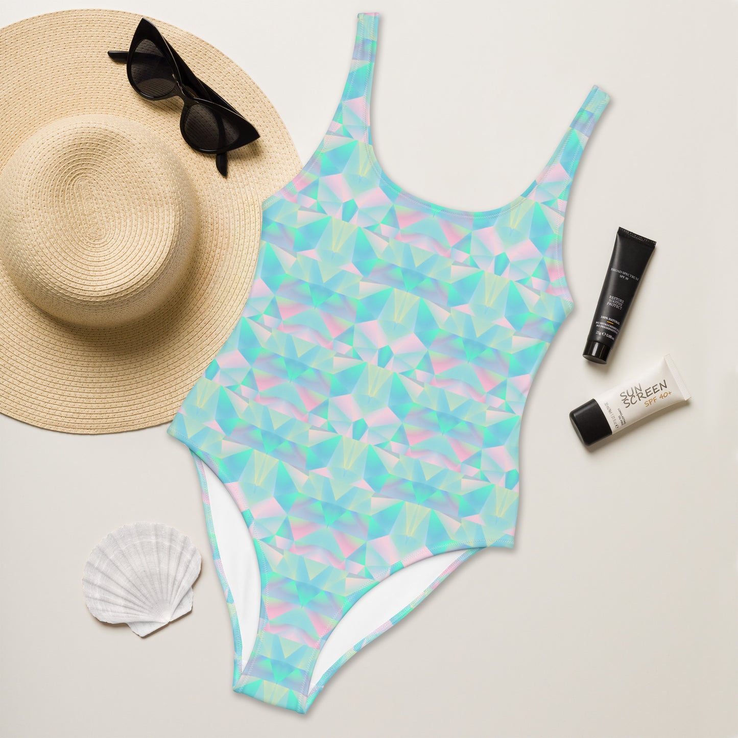Alt Text: Pastel Prisms Blue Geometric One Piece Ladies Bathing Suit. This swimsuit has a geometric prism pattern in shades of pink, blue and purple. This bathing suit is part of our Family Matching Swimwear Collection. Coordinating suits are available in girls sizes 2T-20, ladies sizes, and men’s sizes, by jaecrece