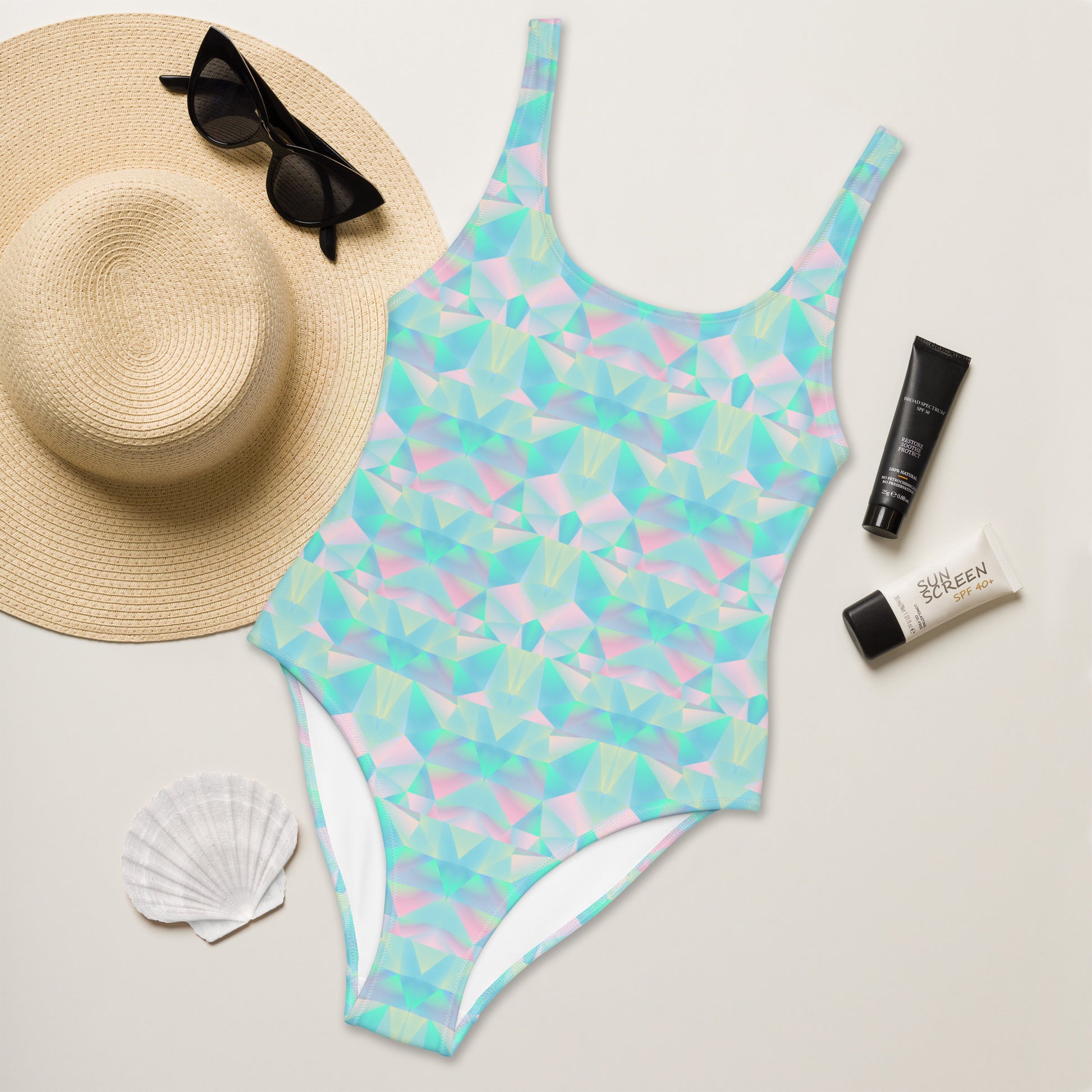 Alt Text: Pastel Prisms Blue Geometric One Piece Ladies Bathing Suit. This swimsuit has a geometric prism pattern in shades of pink, blue and purple. This bathing suit is part of our Family Matching Swimwear Collection. Coordinating suits are available in girls sizes 2T-20, ladies sizes, and men’s sizes, by jaecrece