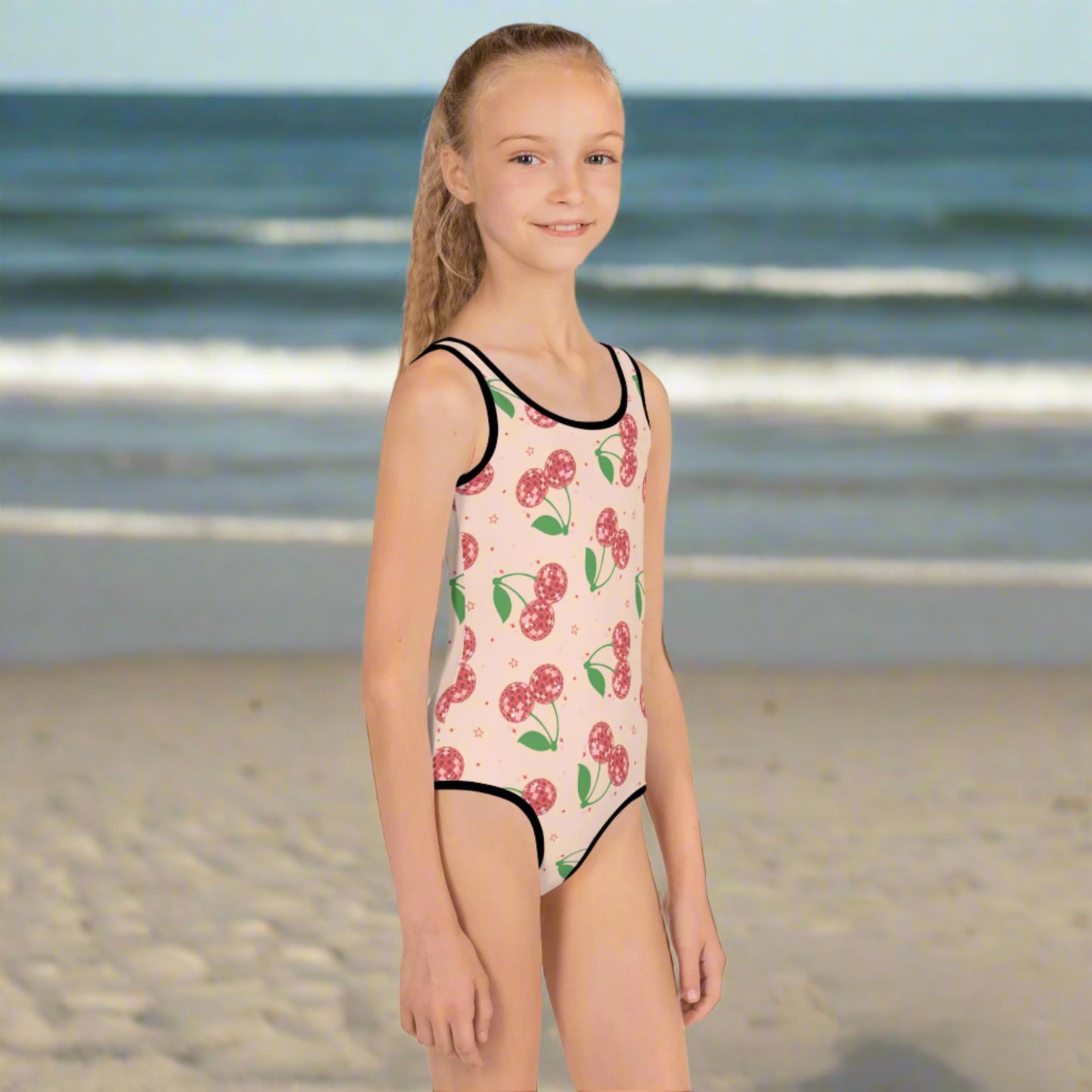 Toddler girl pink swimsuit with red disco cherries, available in sizes 2T–7. Custom matching swimsuit also available in adult sizes for a fun mommy and me look. Features UPF 38–40, durable stretch fabric, and comfy double-layered front. Perfect for summer birthdays, beach vacations, spring break, or poolside twinning with mom. Great gift idea for toddlers, daughters, and nieces.