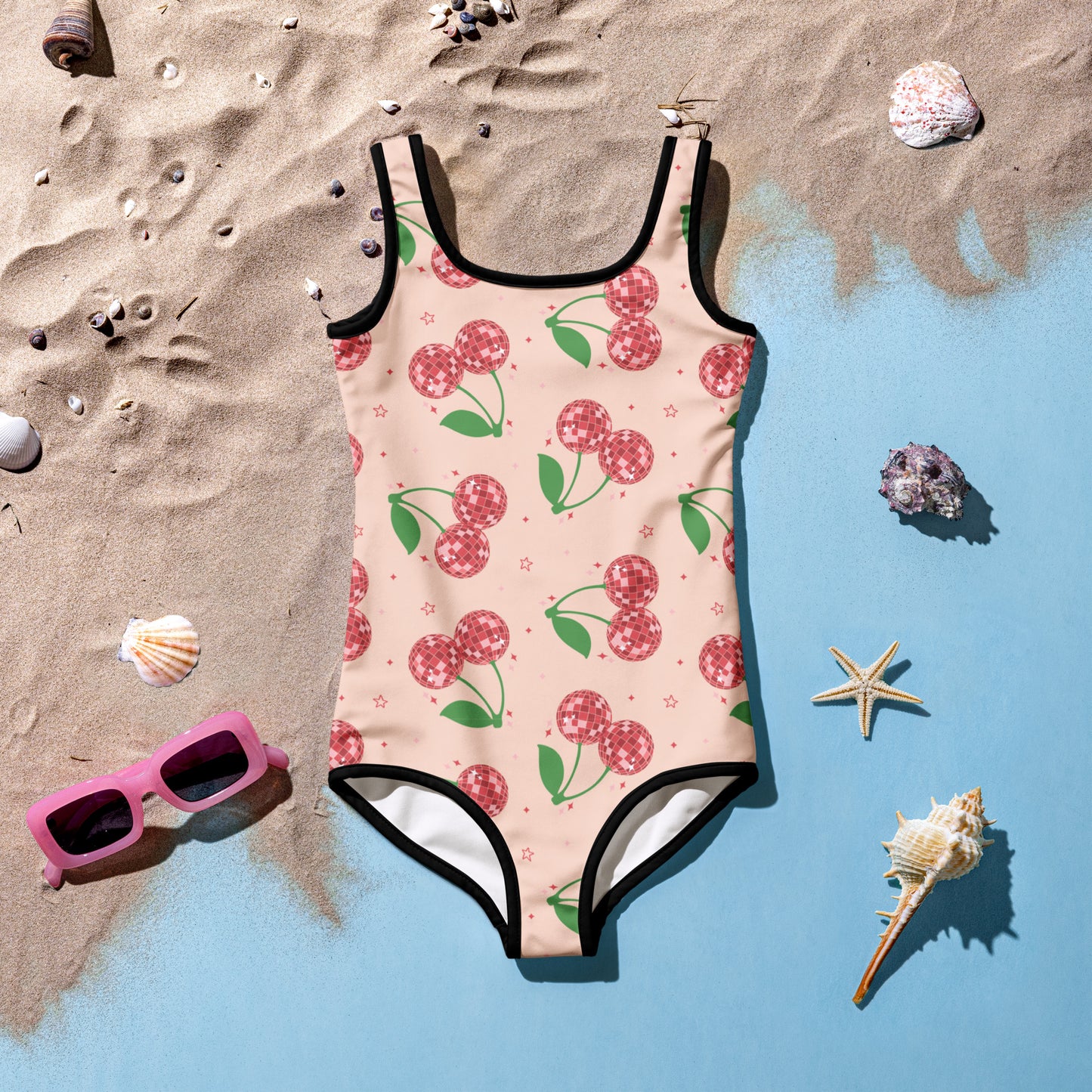 Bright pink girls swimsuit with playful red disco cherry print, perfect for summer family photos at the beach or pool. Designed with durable stretch fabric and UPF 38–40 protection for comfort and sun safety. Available in toddler sizes 2T–7 and coordinates with matching adult swimsuit styles for a cohesive and fun family swimwear look. Great for vacations, holidays, or poolside twinning.