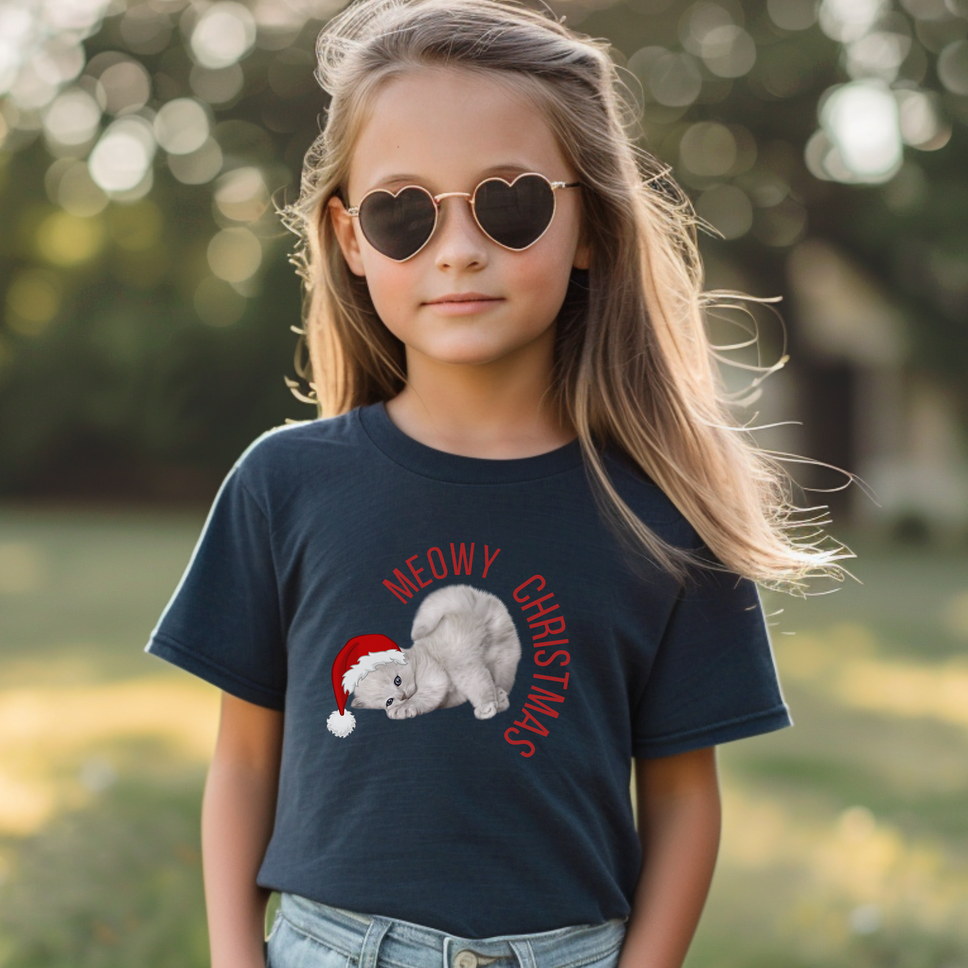 Kids Meowy Christmas tee with cute gray kitten wearing Santa hat, ideal for cat lovers and holiday fun. Youth sizes S–XL, unisex fit, and perfect for family matching Christmas sets. This Christmas cat graphic shirt is cozy, playful, and full of seasonal spirit. Great for Christmas gifts, photos, school parties, and festive family gatherings. A fun, soft, and trendy holiday shirt for kids who love animals.