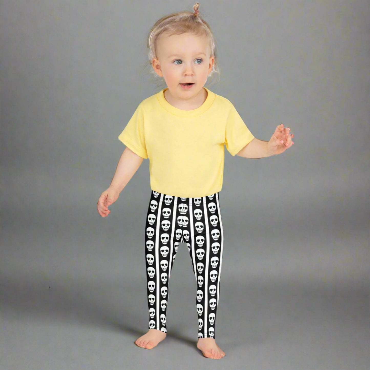 Image: These striped skull leggings for toddlers and kids offer spooky style in a comfy package. The bold black and white stripes give circus vibes while skull details add a fun Halloween touch. Whether paired with a tee or layered under a costume, they’re perfect for themed playdates or festive family photos. Available in multiple child and toddler sizes, by jaecrece.