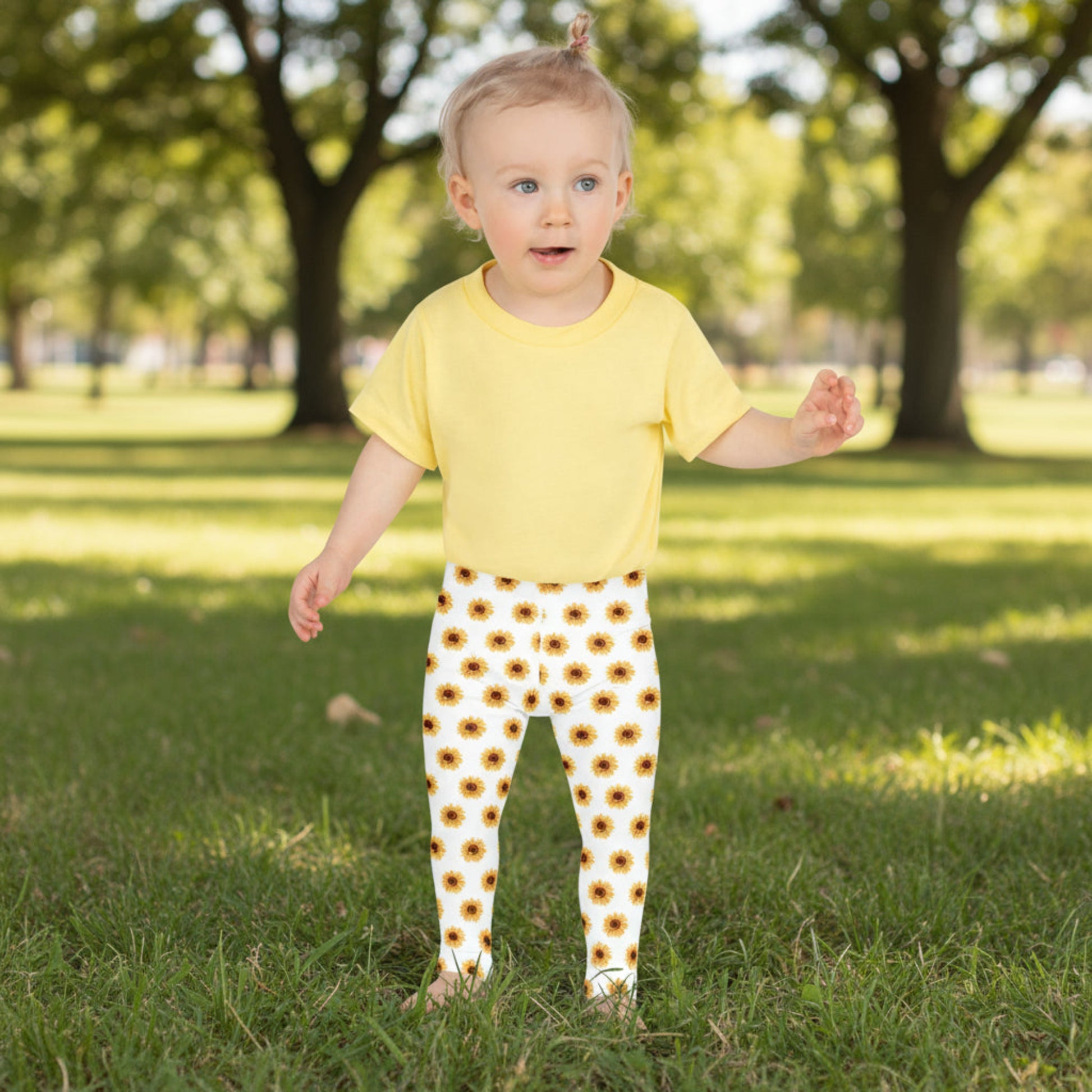 Adorable girls’ sunflower leggings in bright yellow and white, featuring a cheerful floral pattern that celebrates sunshine and playtime. Designed for active toddlers, these full-length, high-rise leggings are soft, stretchy, and made to move. Crafted from durable microfiber with fade-resistant colors, they’re part of a matching sunflower collection for youth and women — perfect for sisters or mommy-and-me outfits.