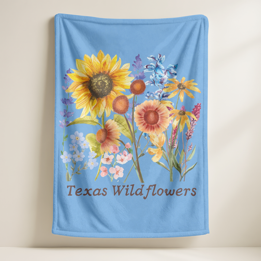 This Texas floral throw blanket showcases a charming wildflower print with watercolor bluebonnets, sunflowers, and delicate pastel greenery. Ideal for spring home decor, baby gifts, or cozying up on the couch, this plush blanket celebrates Texas nature and southern charm. It's a soft and snuggly gift for moms, gardeners, and fans of wildflower or botanical print home accents.