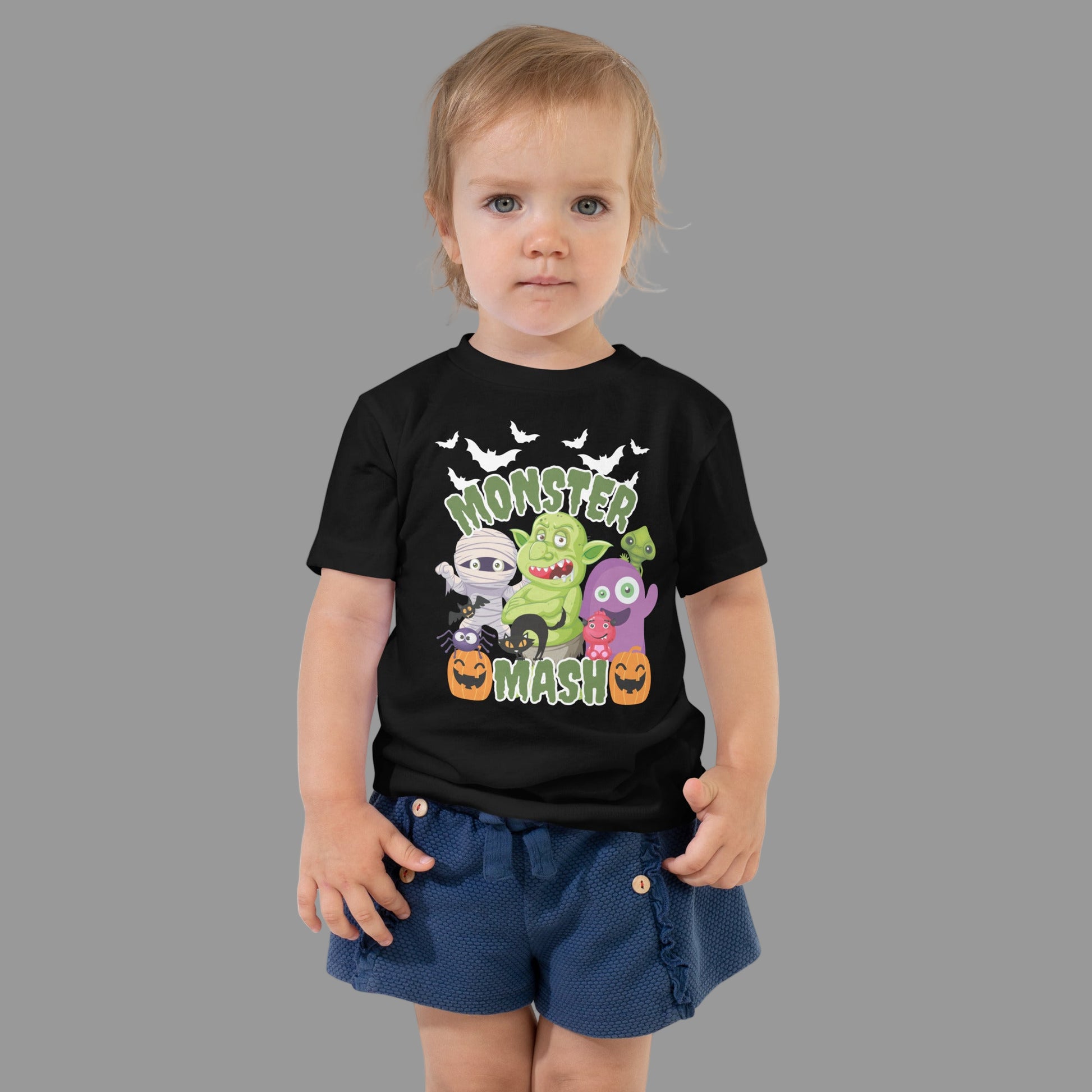 Monster Mash toddler Halloween t-shirt in black featuring cartoon monsters including a mummy, black cat, troll, pumpkins, spider, and bats. This cute unisex toddler tee is soft, durable, and available in sizes 2T–5T, making it perfect for trick-or-treating, school parties, or everyday spooky season wear. A fun family matching Halloween shirt for mommy and me, sibling sets, or group costumes, this toddler monster tee is an adorable festive outfit choice.