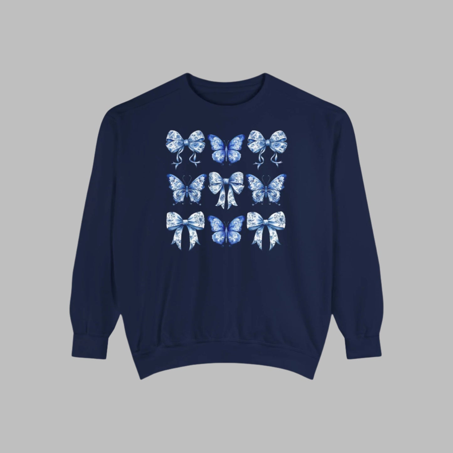 Image: Elegant yet comfortable sweatshirt for women with blue toile butterflies and bows, blending classic charm with modern softness. Sized XS to XL and designed for matching with toddlers and girls, this sweatshirt brings Texas coquette and coastal cowgirl fashion into the family wardrobe. A must-have for casual spring days, by jaecrece.