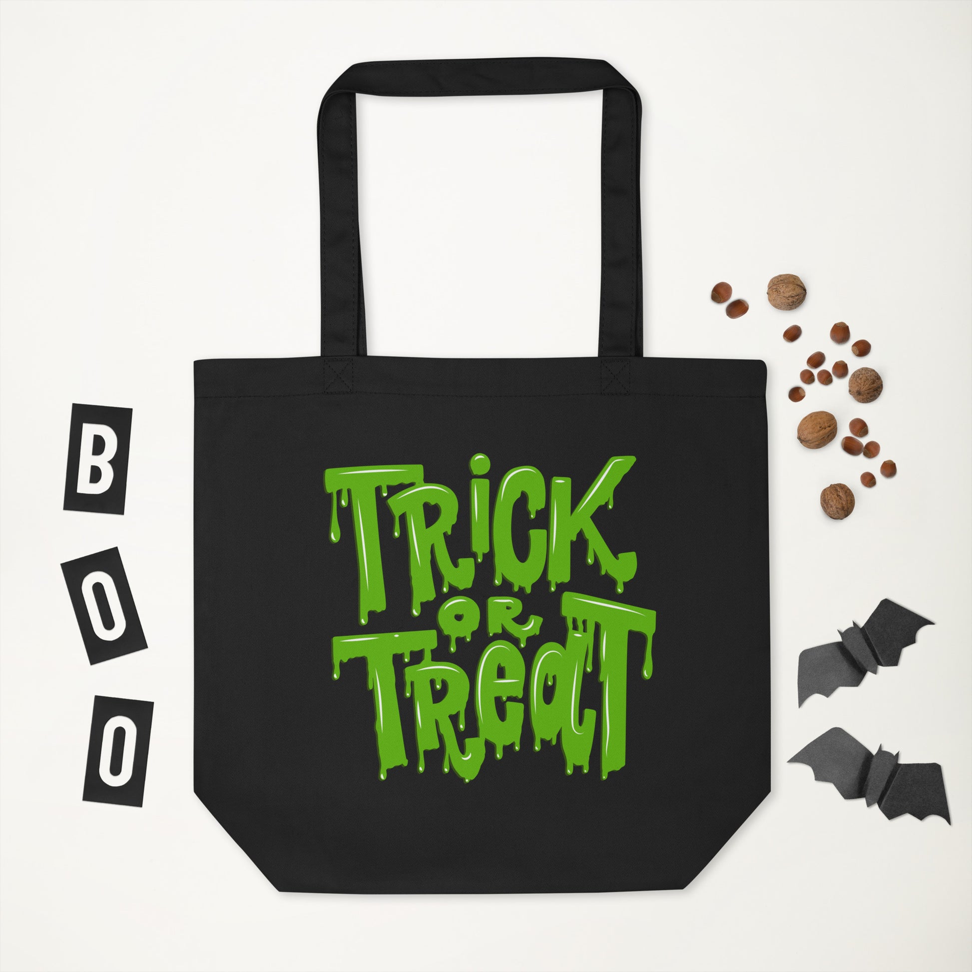 Halloween Trick or Treat Tote Bag with green slime design on black organic cotton, perfect for candy hauls and eco-conscious families. Spacious, strong, and reusable, this tote is a fun upgrade from plastic buckets and can carry up to 30 lbs. Whether for trick-or-treating, Halloween parties, or daily errands, this eco-friendly Halloween bag offers durability, spooky style, and sustainable functionality year after year.