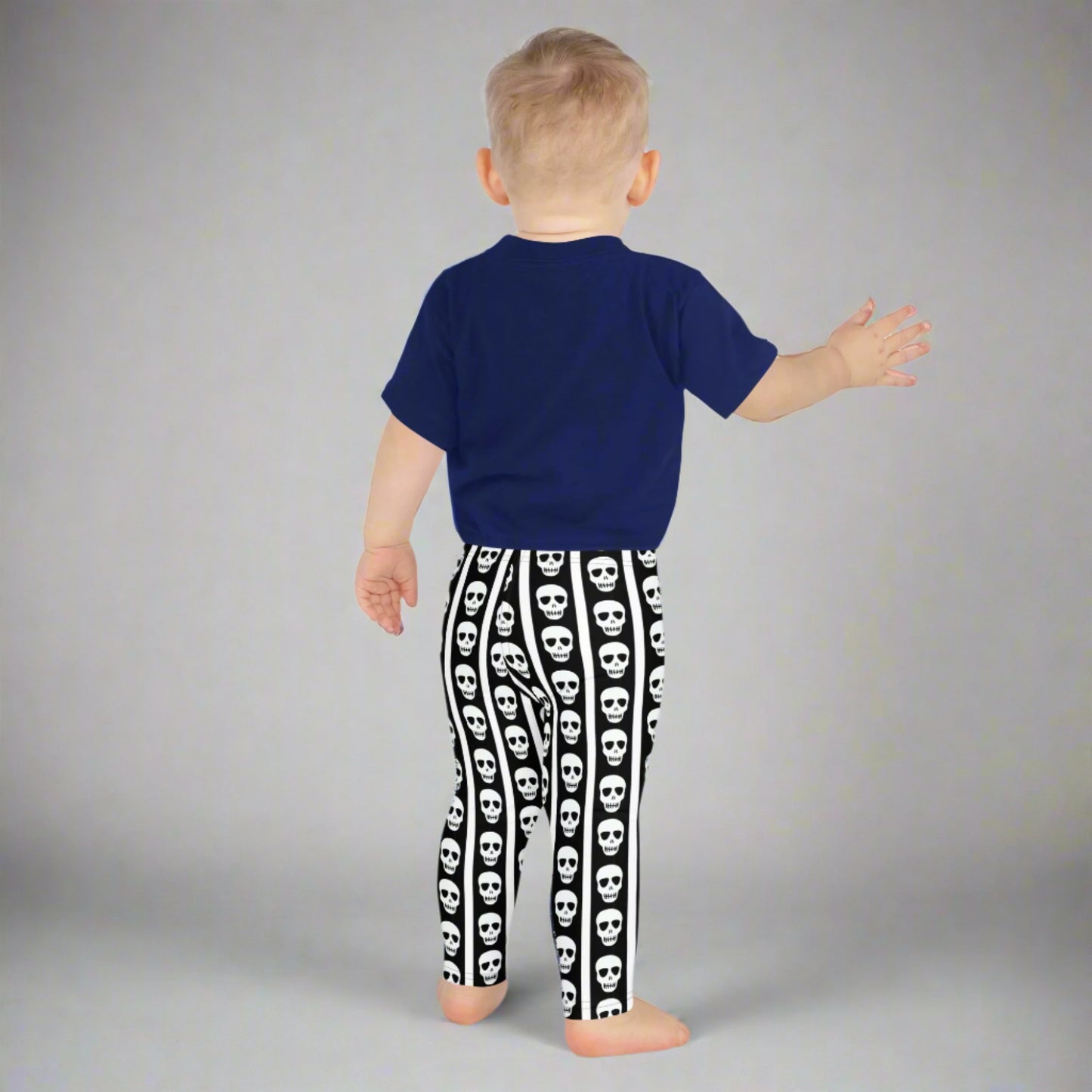 Image: For spooky season or year-round fun, these kids leggings feature vertical stripes in black and white with skulls lined up on each leg. Designed with comfort and play in mind, these soft leggings are ideal for imaginative dress-up or casual outings. Offered in toddler and youth sizes, they bring playful edge to every outfit for your tiny trendsetter, by jaecrece.