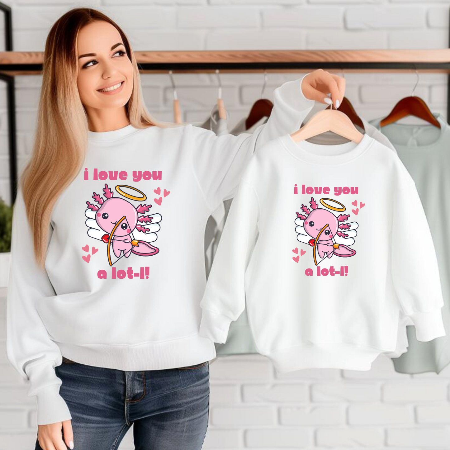 Love You A Lot-L Unisex Organic Raglan Sweatshirt. Axolotl Cupid for Women. Black sweatshirt with cute pink graphic of a cupid axolotl shooting a bow and arrow. This eco friendly pullover makes a great Valentine gift for animal lovers, by jaecrece