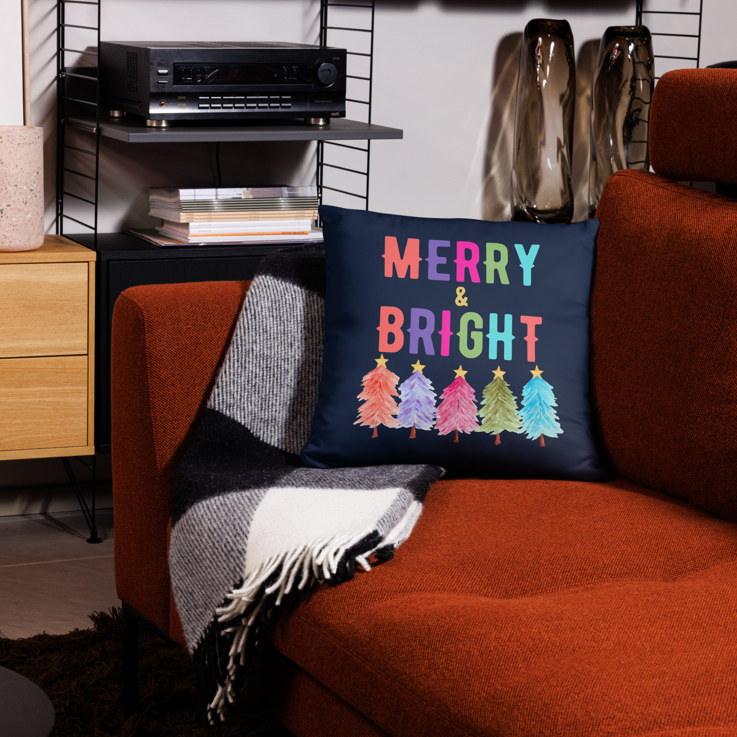 Merry & Bright Christmas Throw Pillow, Holiday Home and Patio Decor. This square pillow has a deep blue navy background, with Merry & Bright printed in Coral, Purple, Pink, Green, Teal. This pillow also features Christmas trees in the same colors. by jaecrece