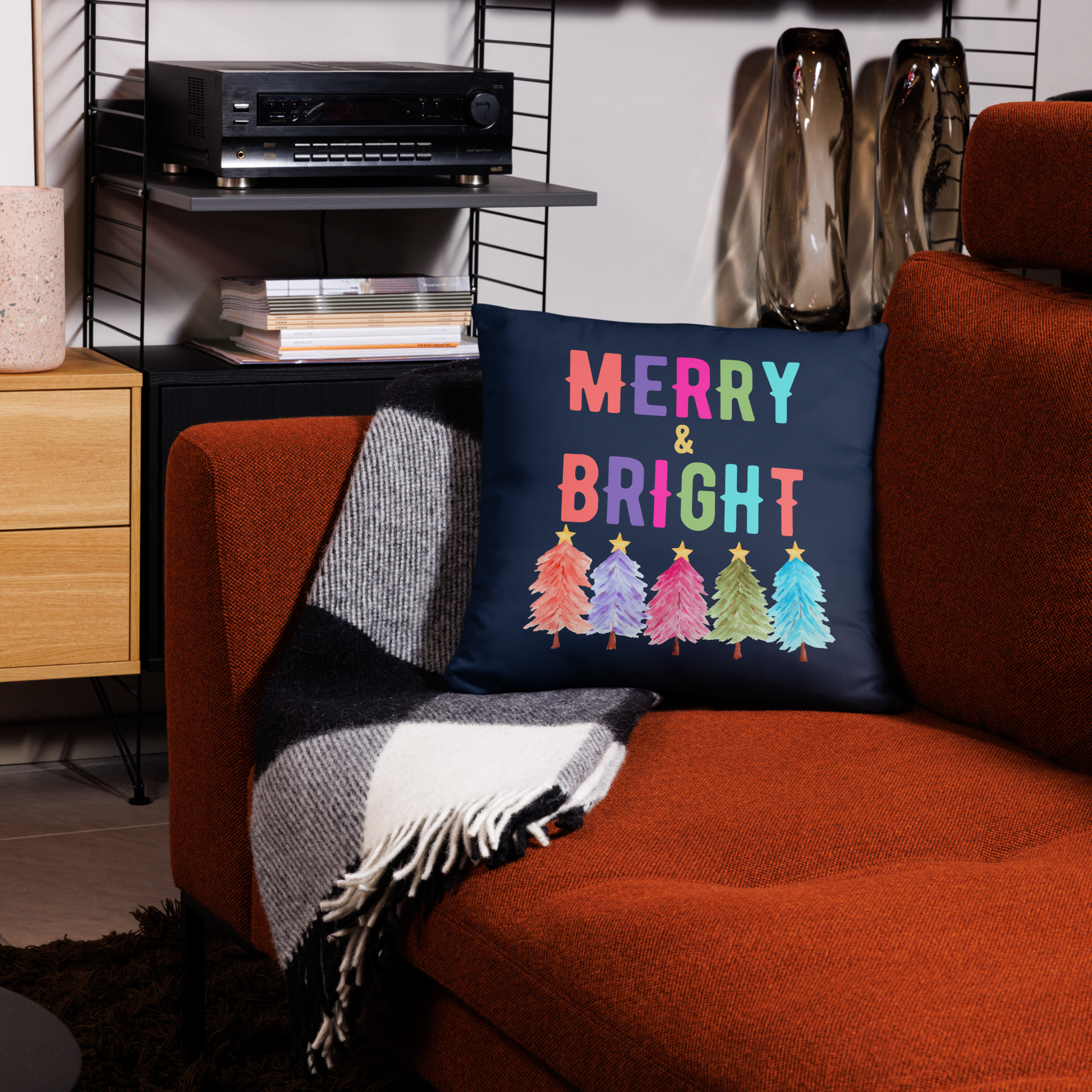 Merry & Bright Christmas Throw Pillow, Holiday Home and Patio Decor. This square pillow has a deep blue navy background, with Merry & Bright printed in Coral, Purple, Pink, Green, Teal. This pillow also features Christmas trees in the same colors. by jaecrece