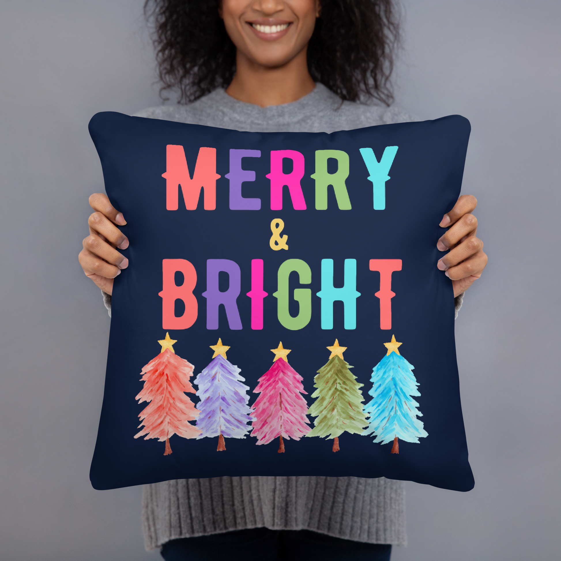 Merry & Bright Christmas Throw Pillow, Holiday Home and Patio Decor. This square pillow has a deep blue navy background, with Merry & Bright printed in Coral, Purple, Pink, Green, Teal. This pillow also features Christmas trees in the same colors. by jaecrece